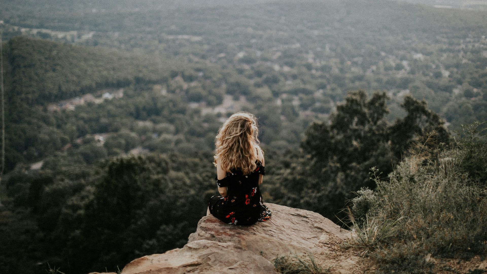 woman siting on cliff