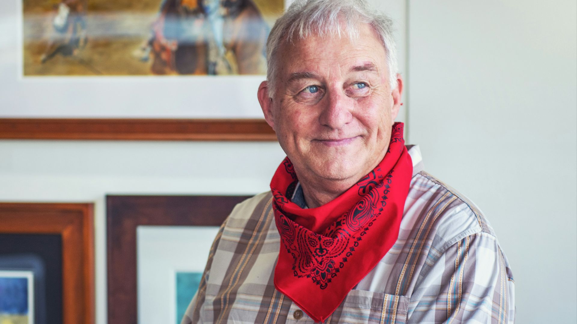 man in gray and white plaid dress shirt and red scarf