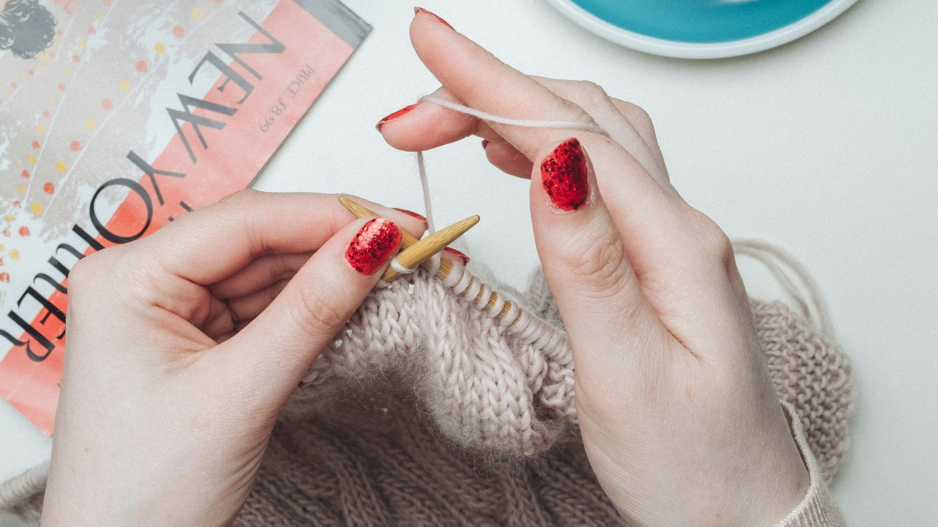 person knitting beige garment