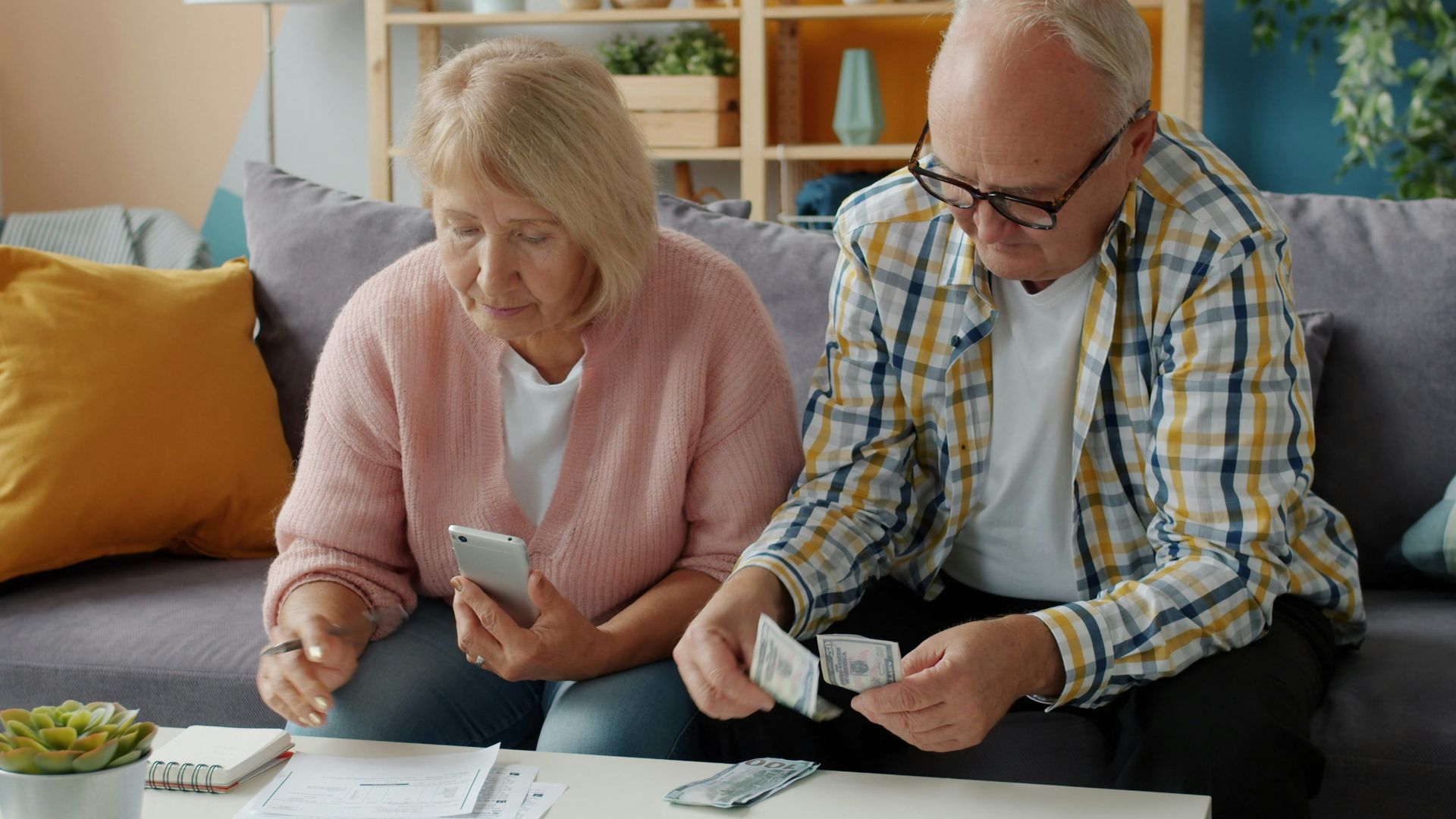 Elderly couple managing finances at home