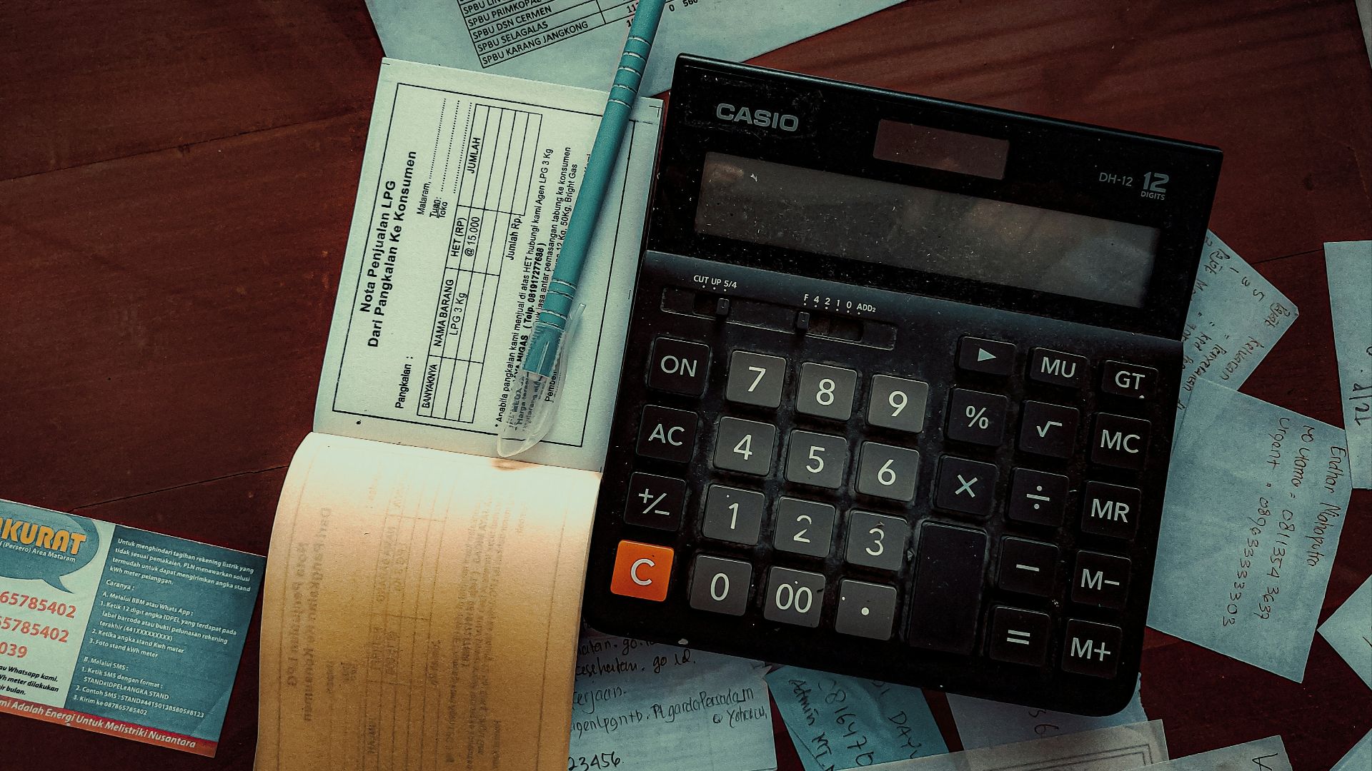 a calculator sitting on top of a wooden table