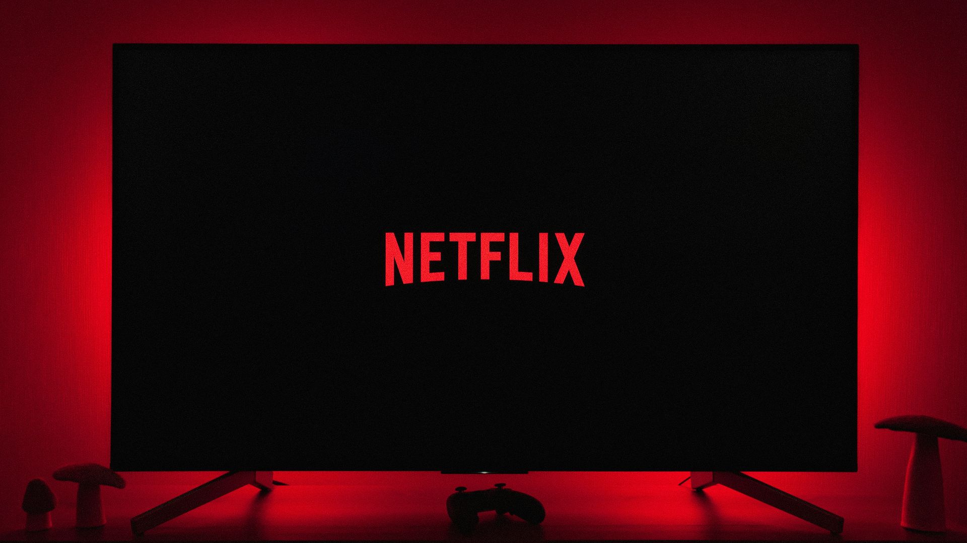 a television with the netflix logo lit up in the dark