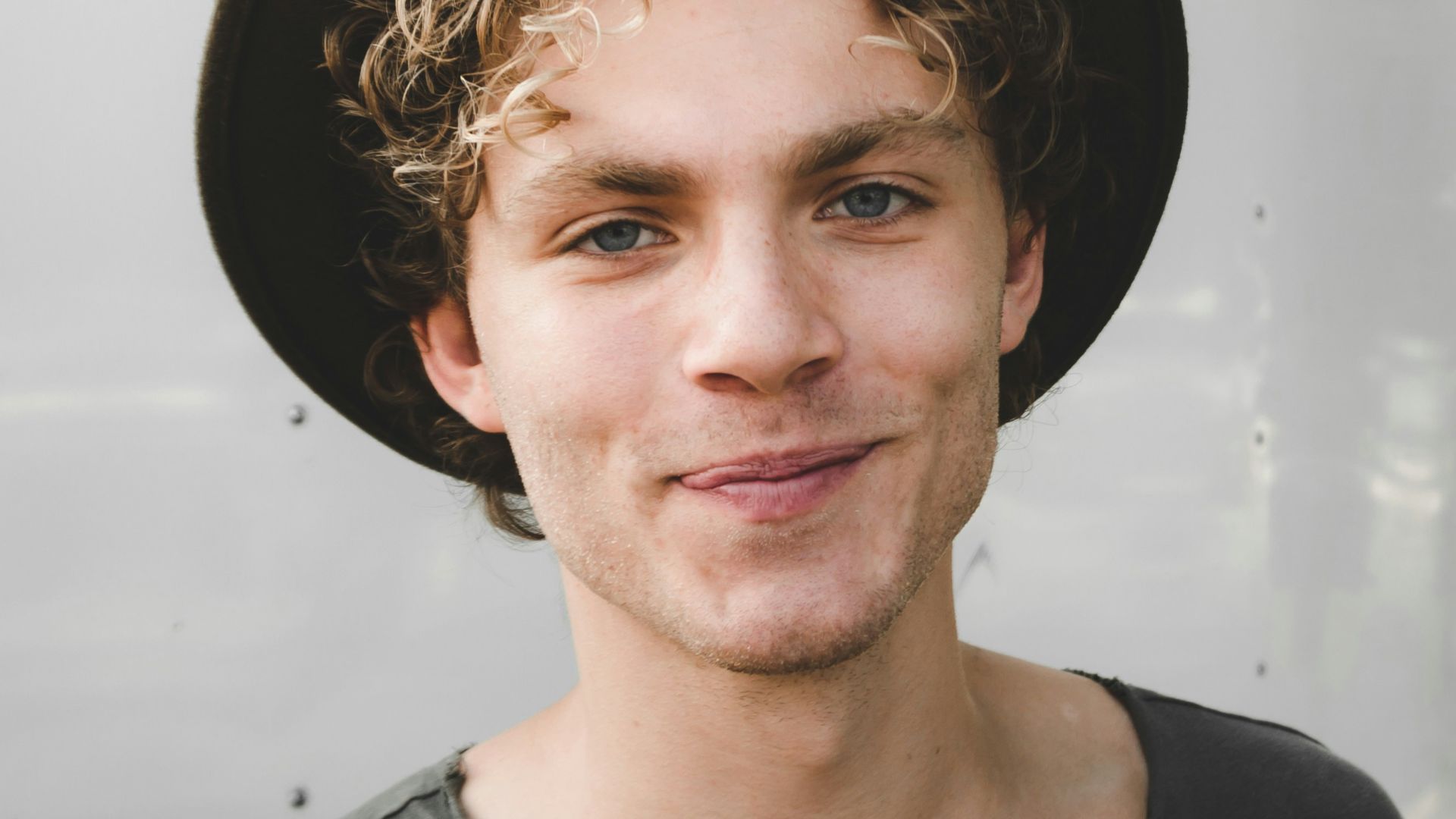 man standing near white wall