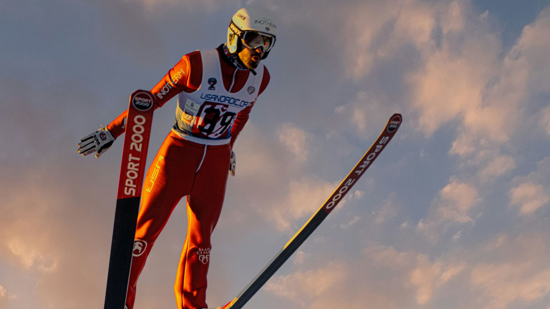 a man flying through the air while riding skis