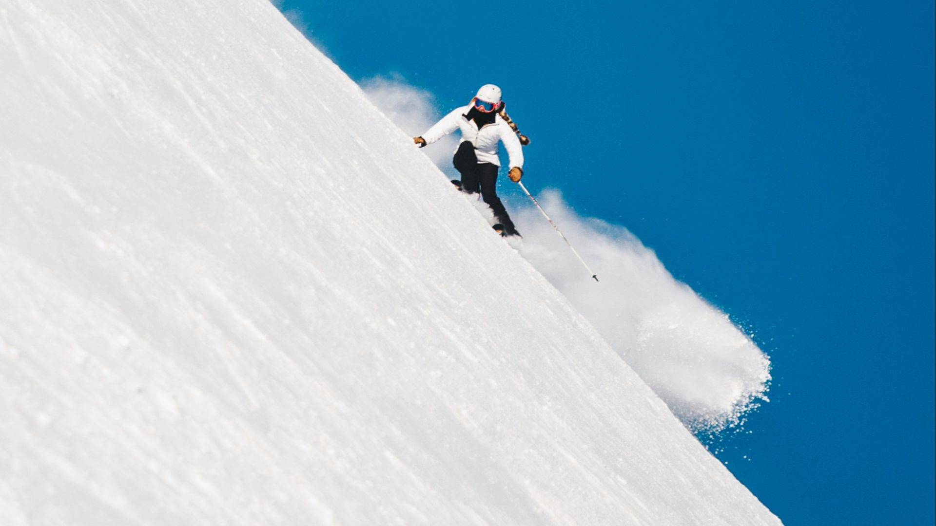 person snowboarding on mountain cliff