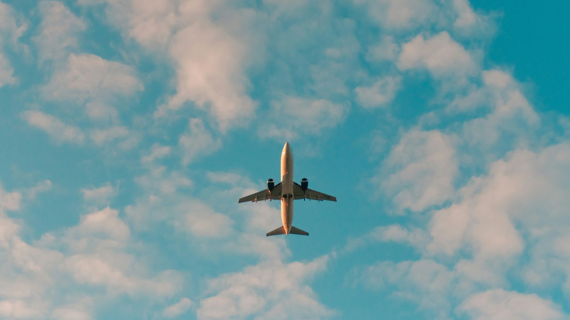white airplane flying in the sky during daytime
