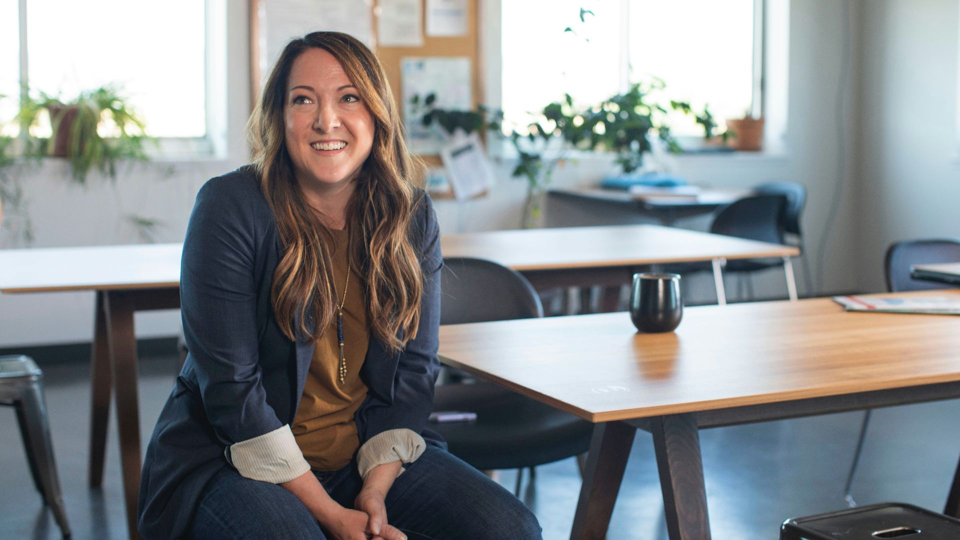 woman in black blazer sitting on chair