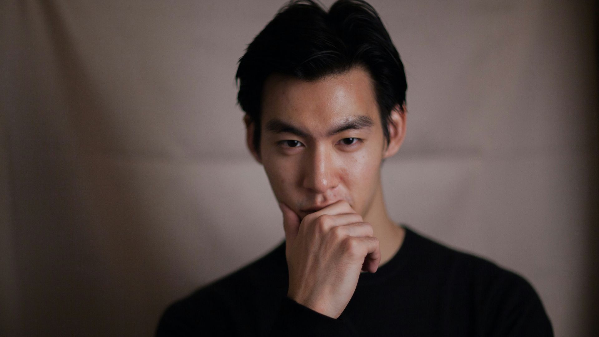 man touching his chin with right hand