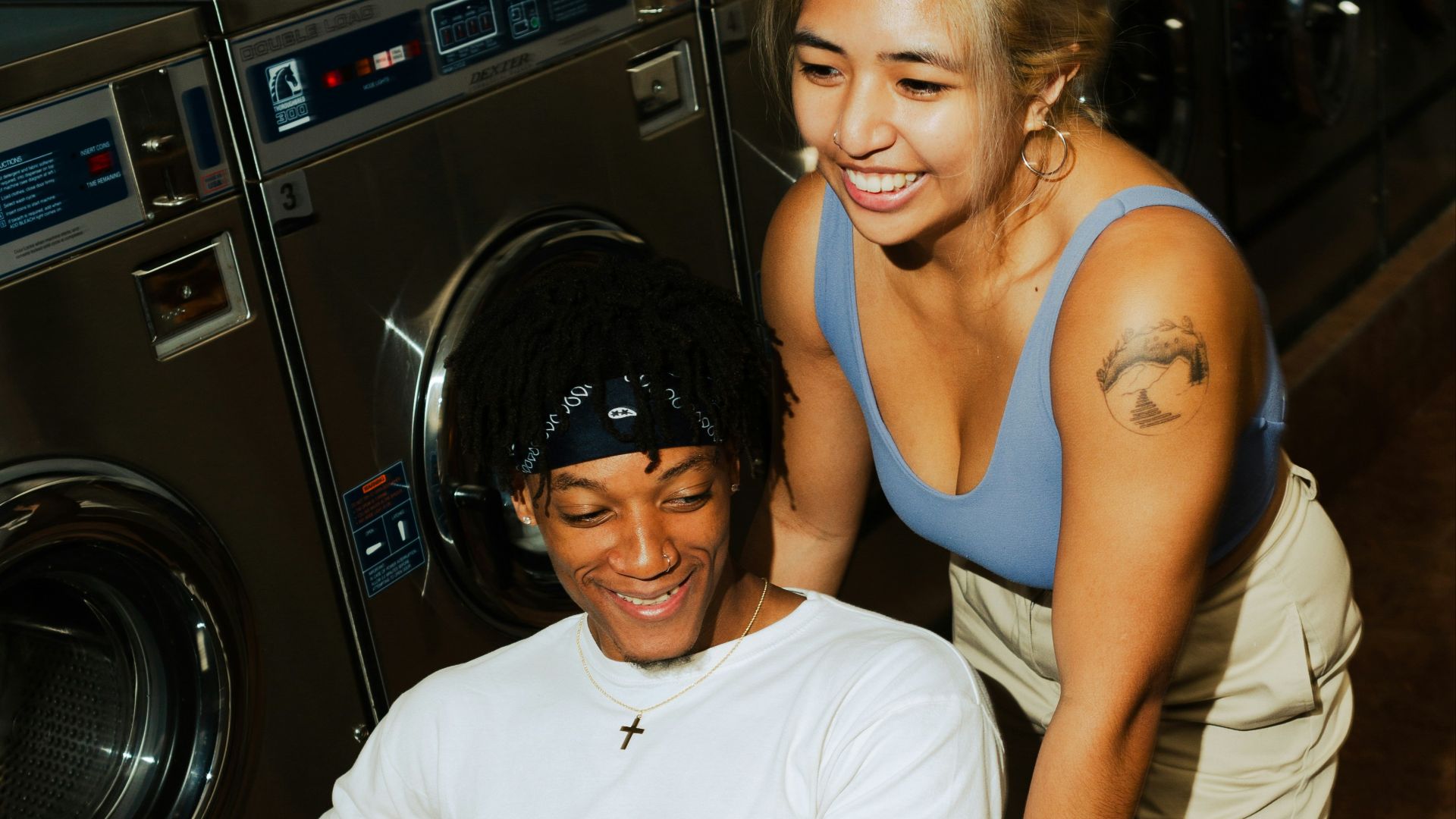 man in white crew neck t-shirt sitting beside woman in blue tank top