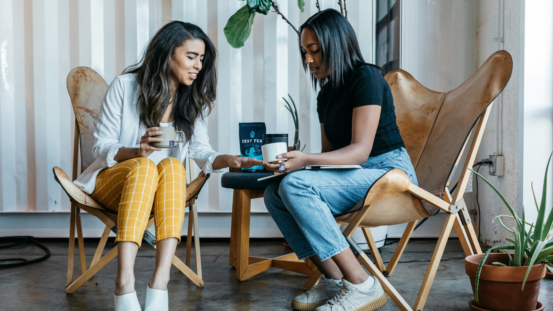 woman in black shirt sitting on brown wooden chair