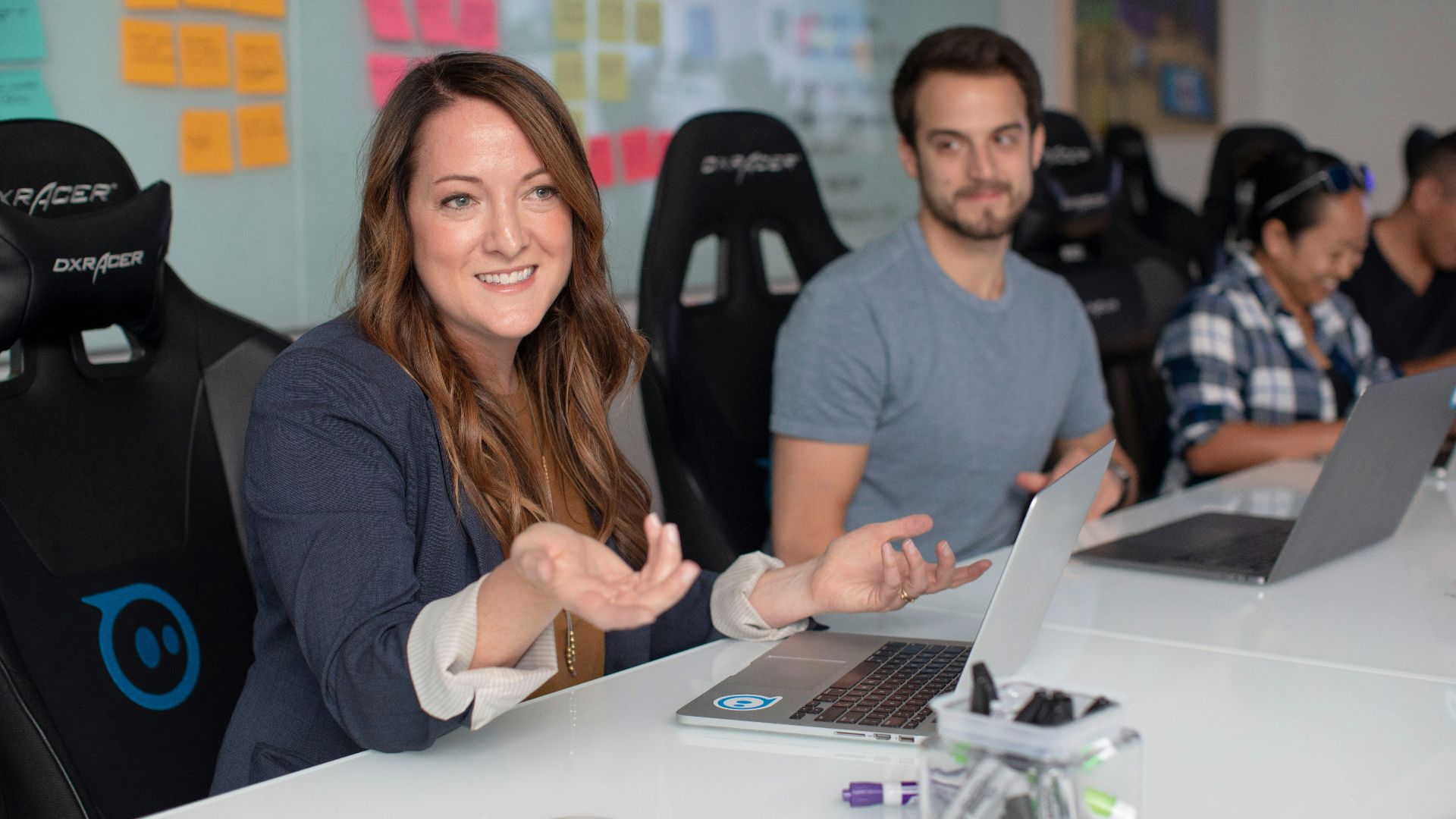 woman in black long sleeve shirt sitting beside man in gray crew neck shirt