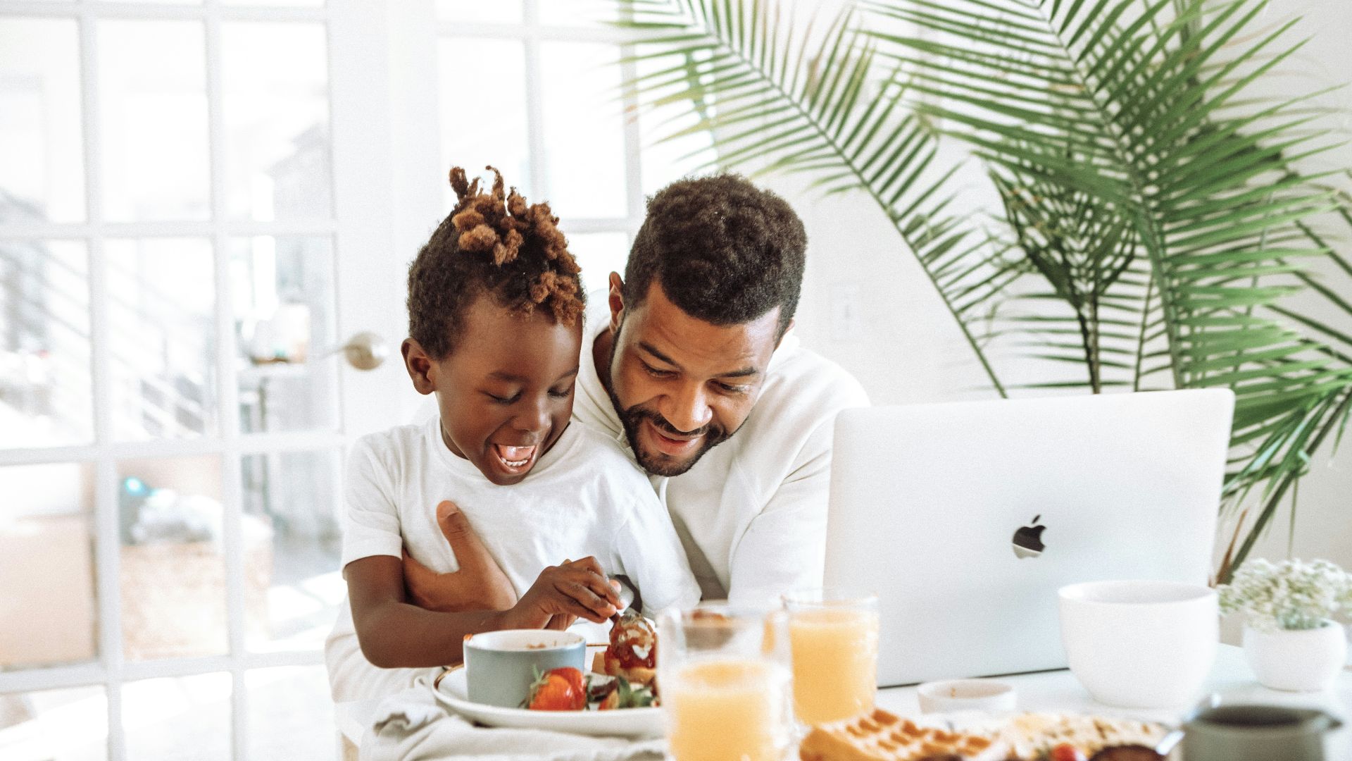 man and woman sitting on white couch