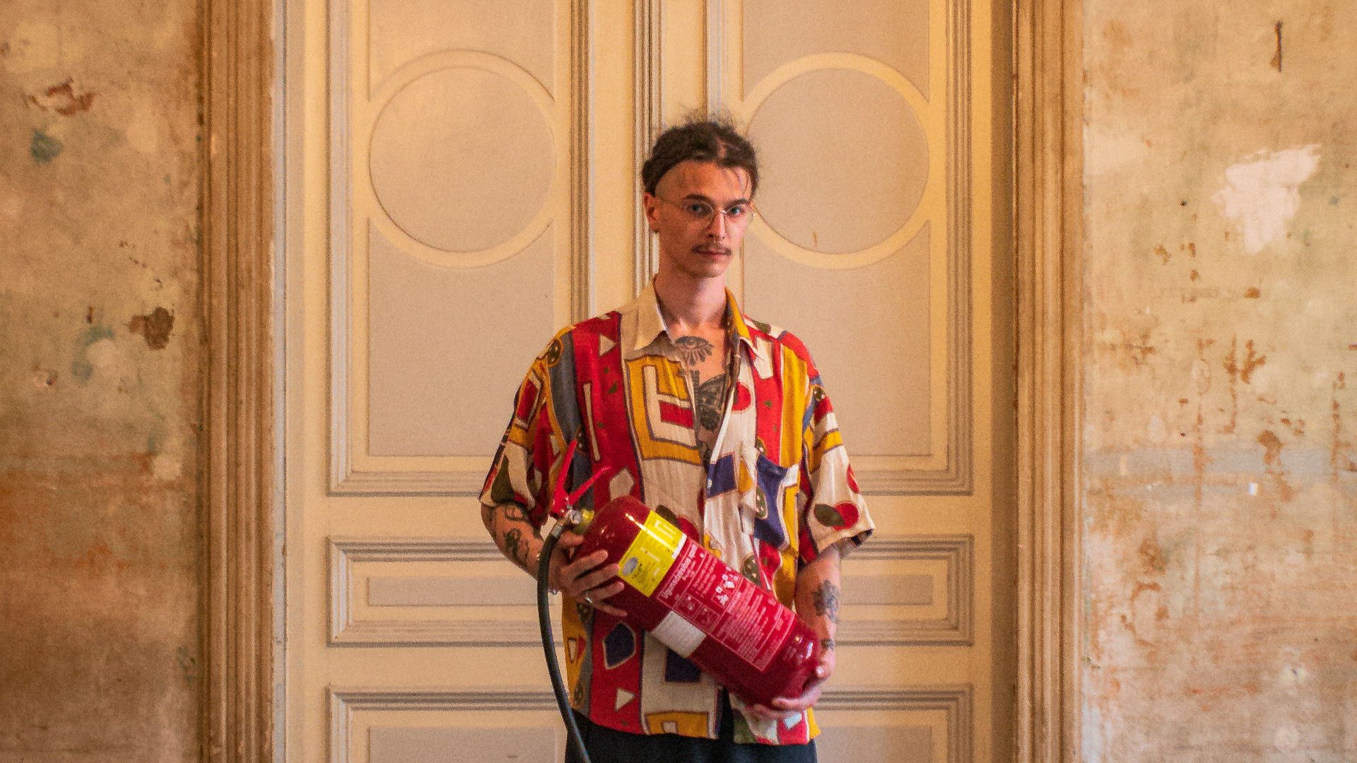 a man standing in front of a door with a hose