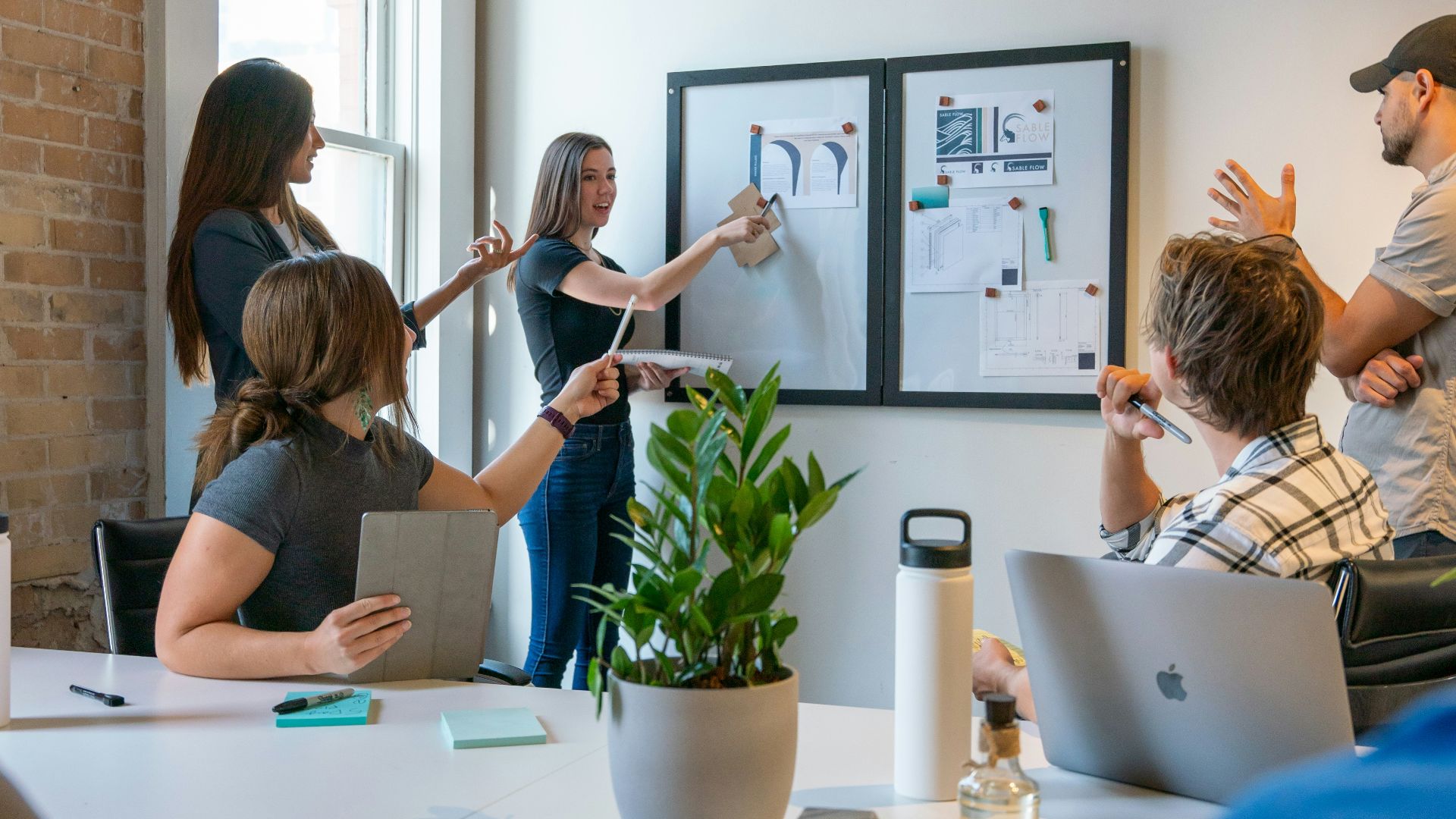 a group of people sitting around a white table