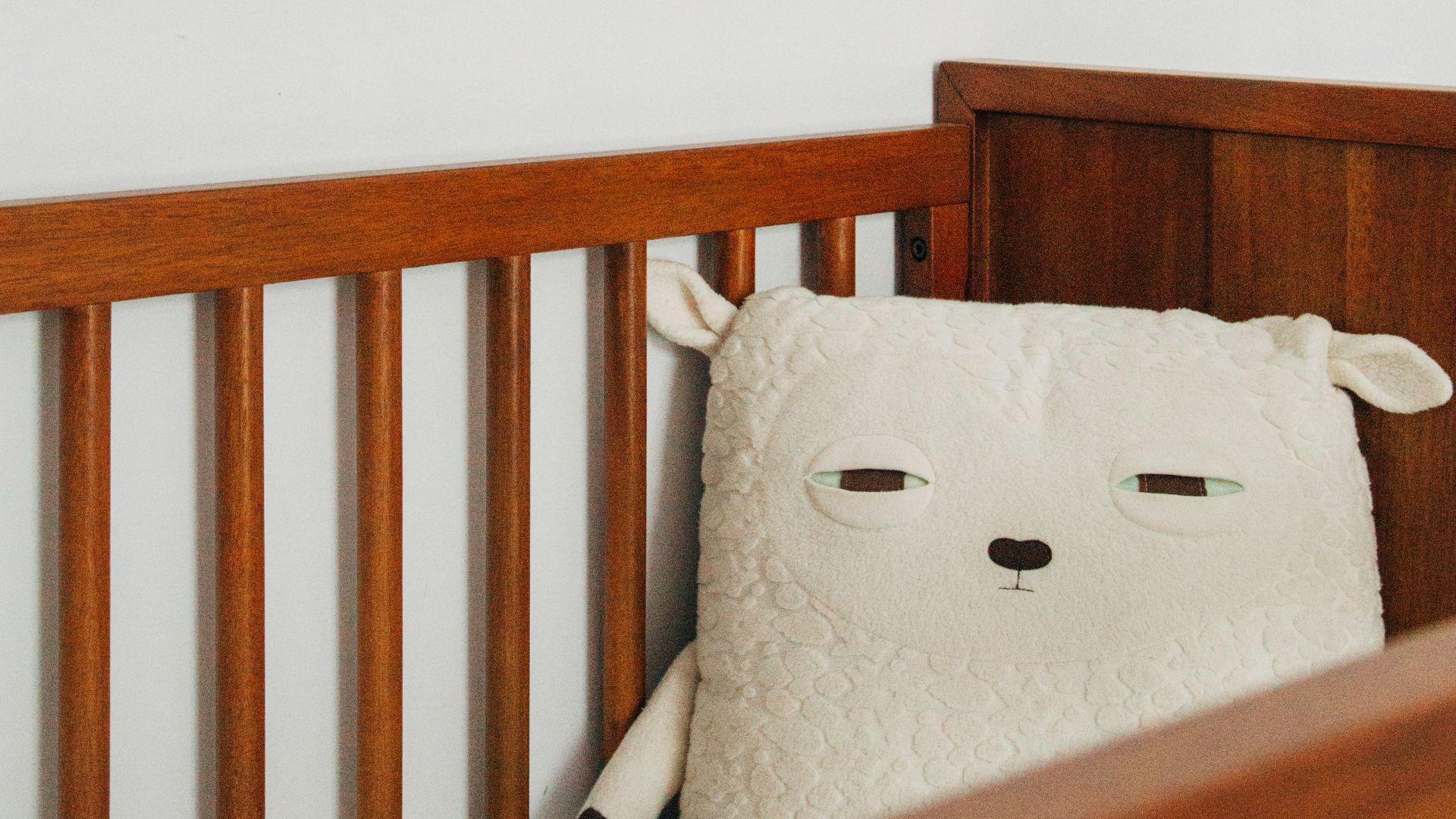 crib with sheep pillow and crib mobile