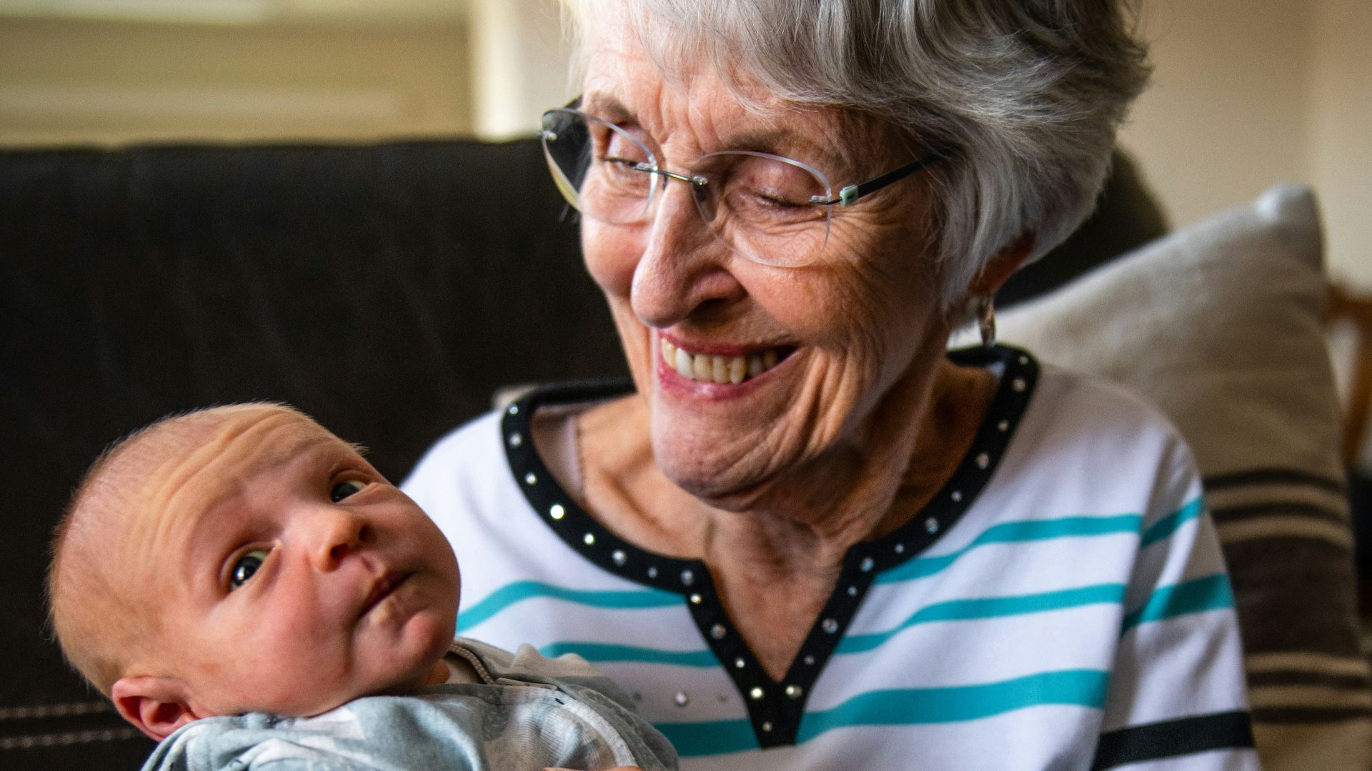 an older woman holding a baby