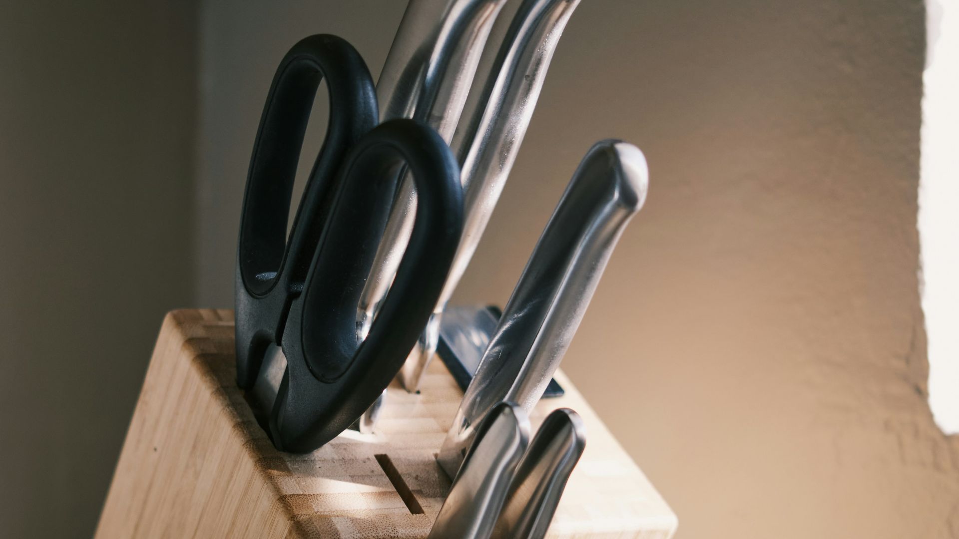 a wooden block with a knife holder holding knives