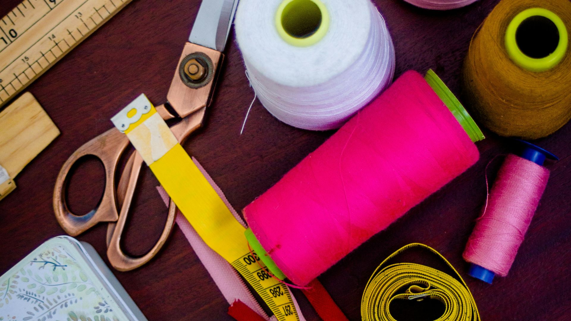 threads with spools beside scissors