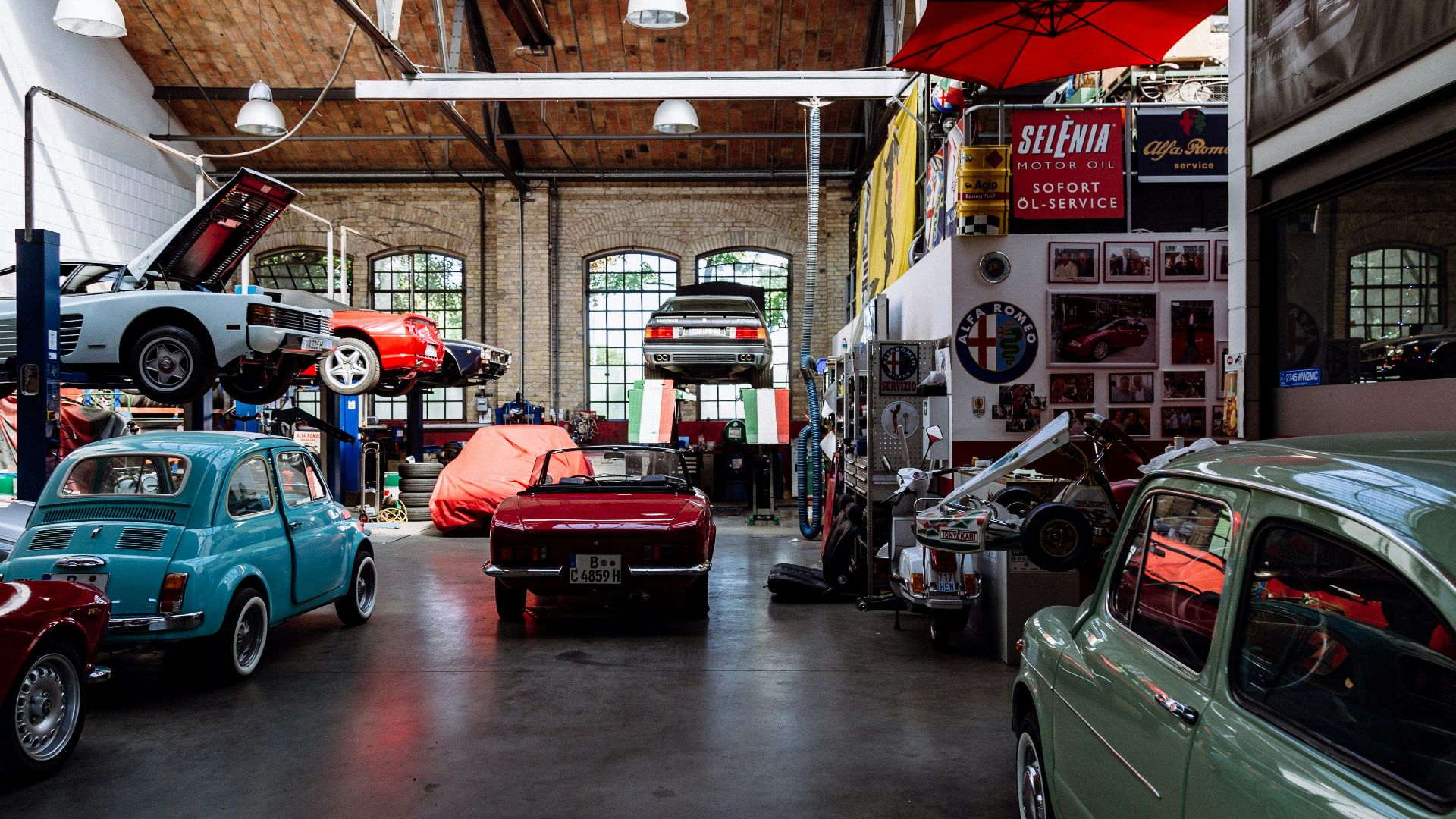 several vehicles parked beside wall