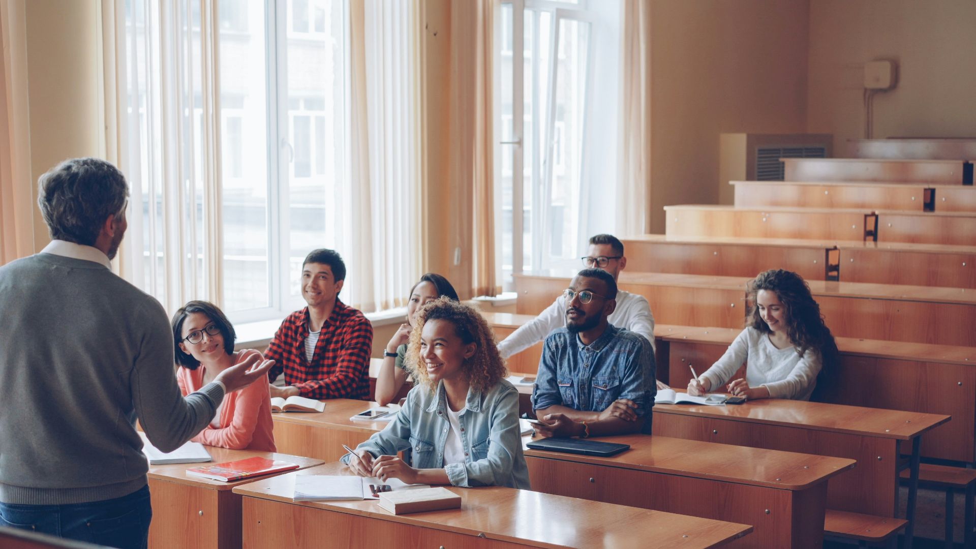 Professor teaching students in a lecture hall.