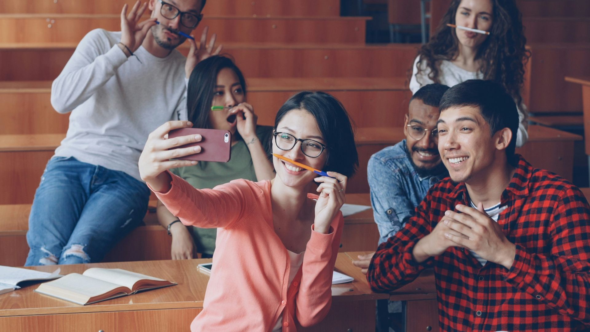 Students taking a selfie in a lecture hall