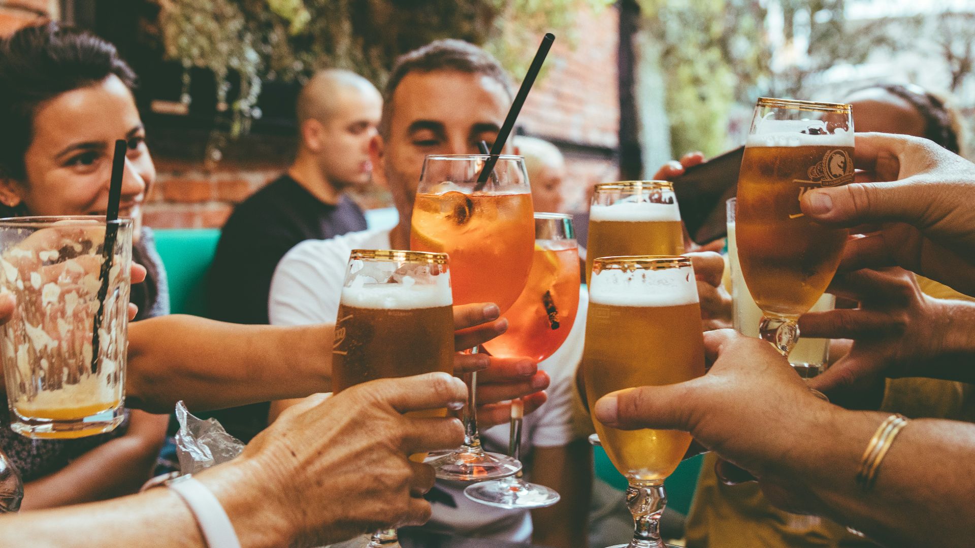 people holding drinks during day