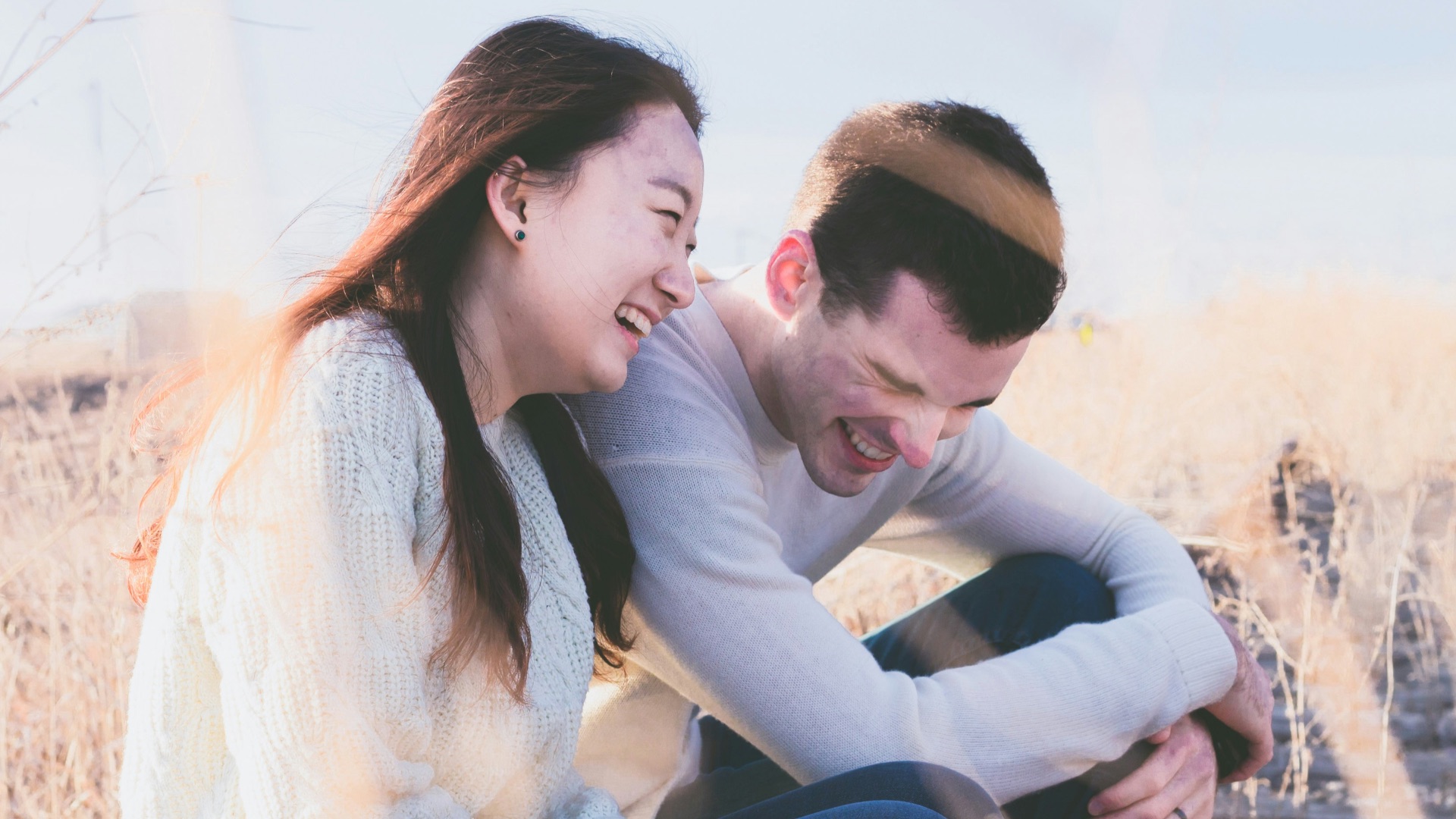 photo of man and woman laughing during daytime