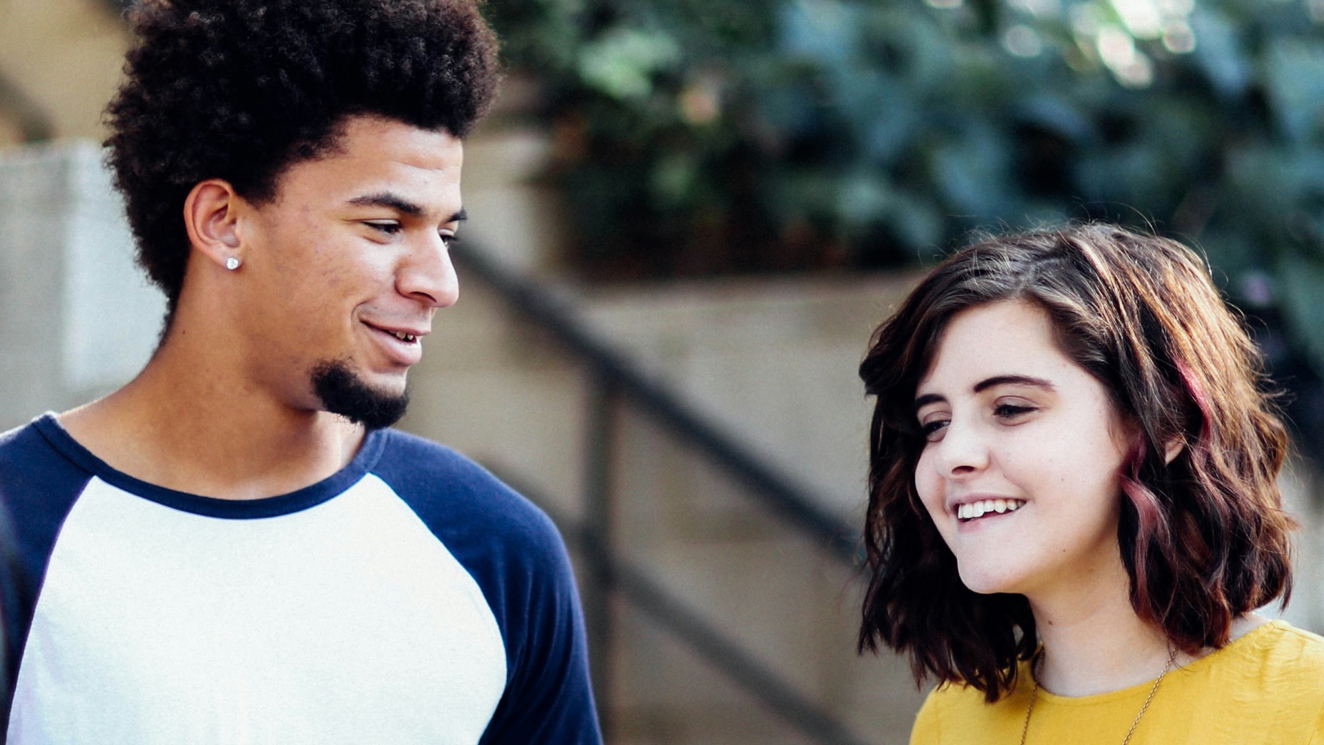 women and man talking outside the building