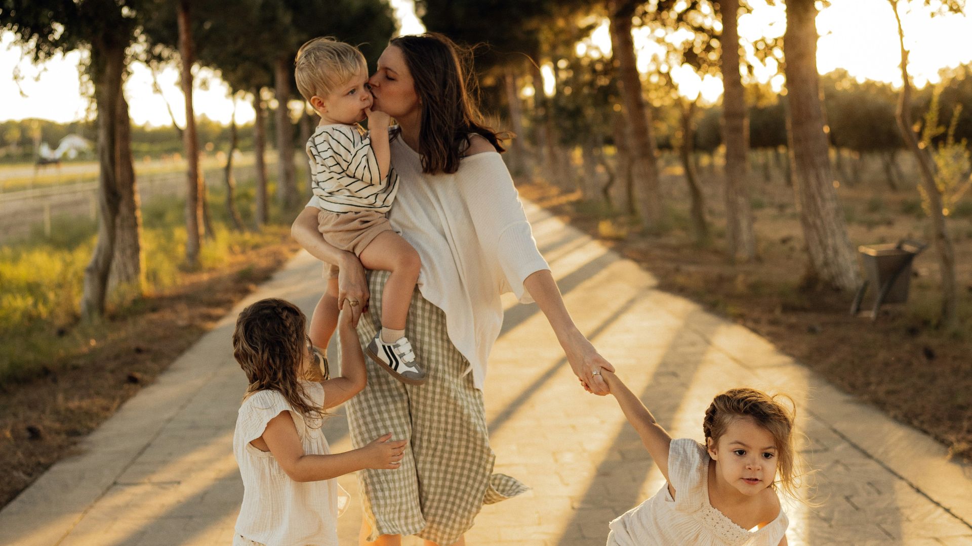 Mother with three children walking on a path