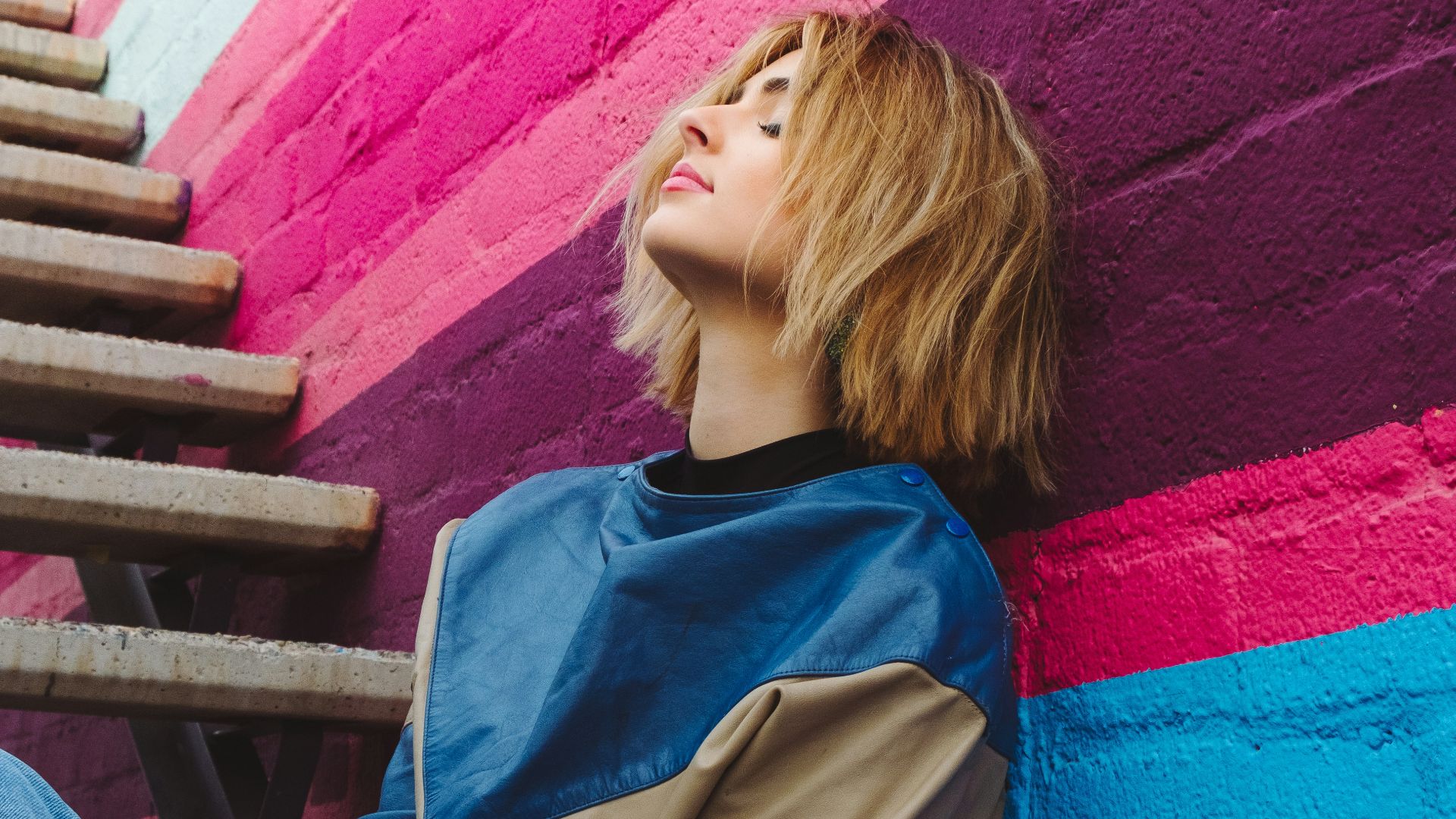 woman leaning on wall