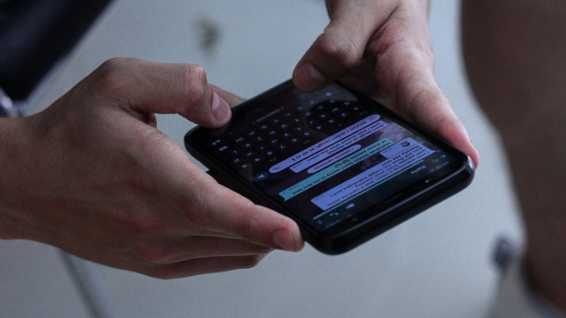 person holding black iphone 4