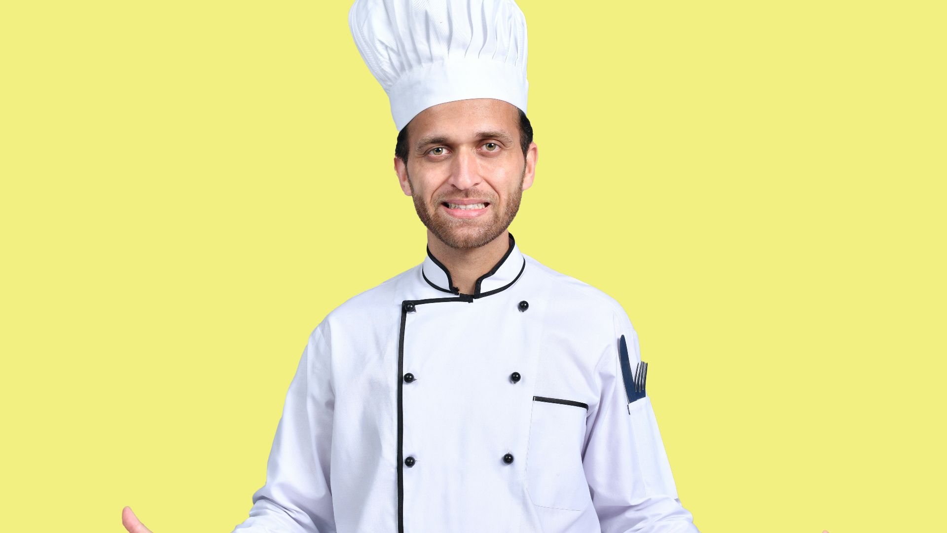 a man wearing a chef's hat and standing in front of a yellow background