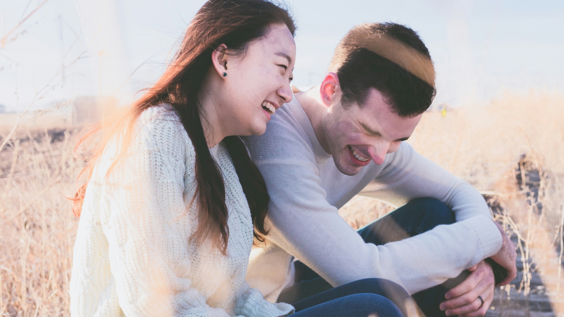 photo of man and woman laughing during daytime