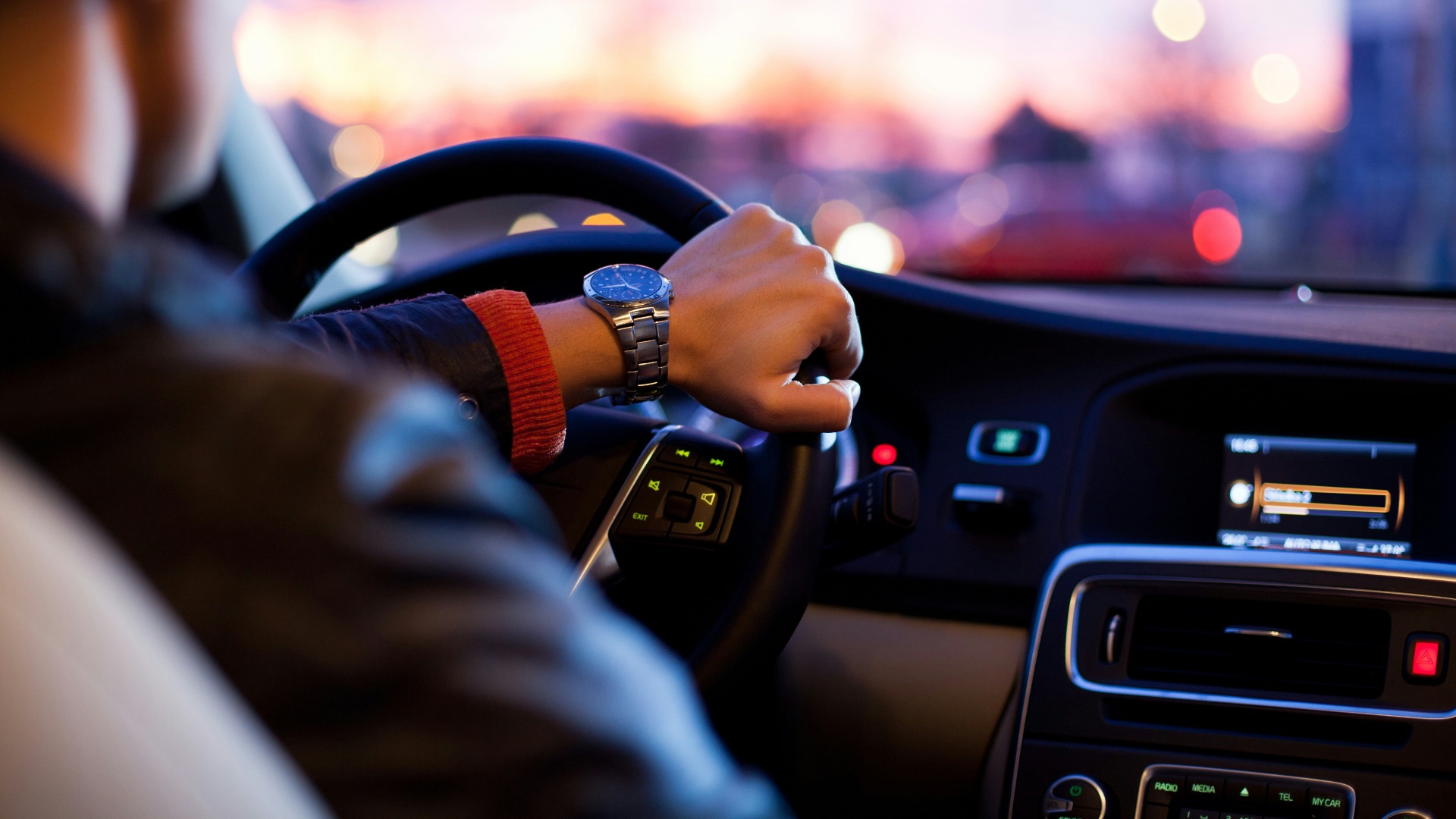 man driving a car wearing wrist watch