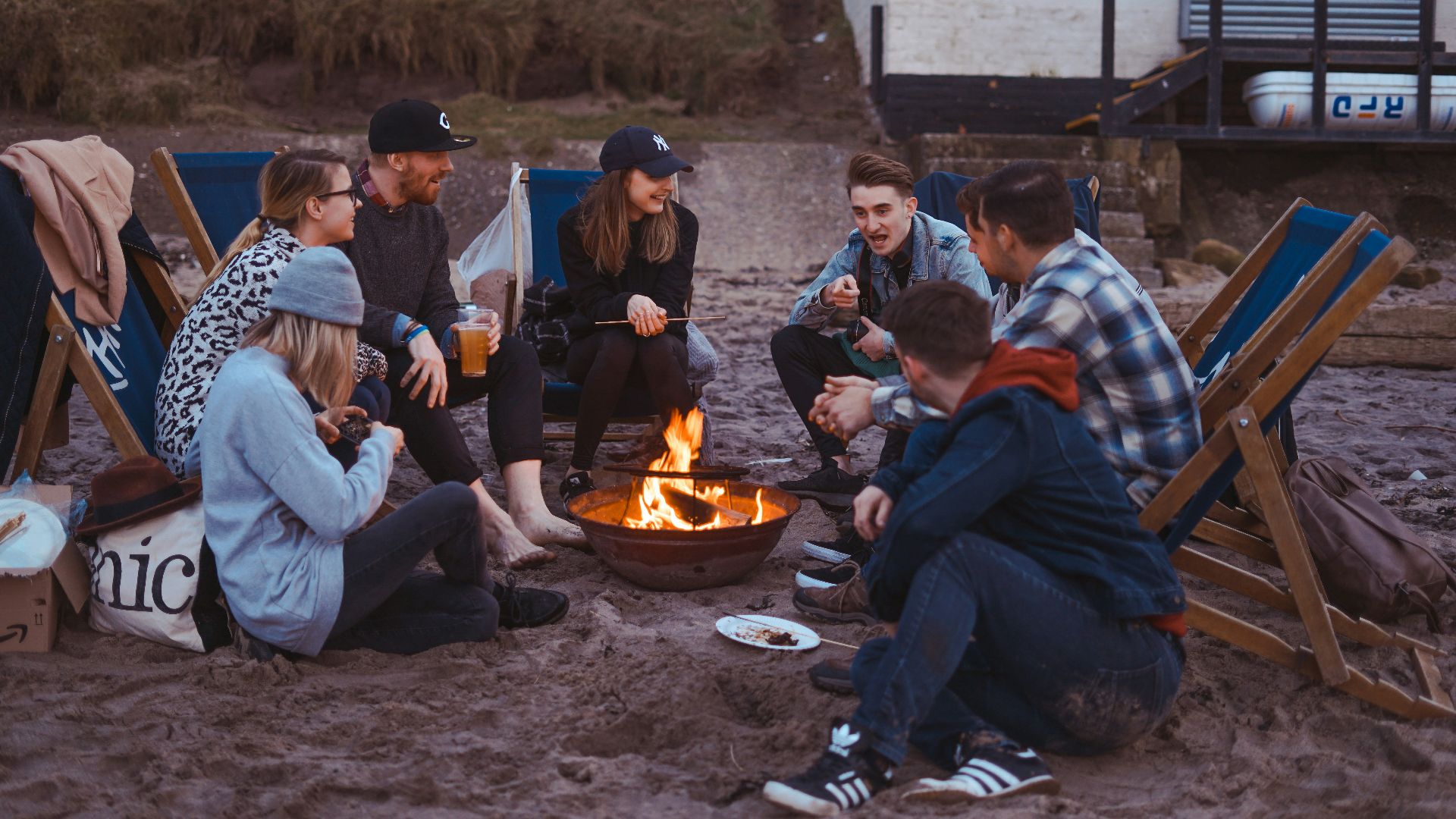 group of people sitting on front firepit