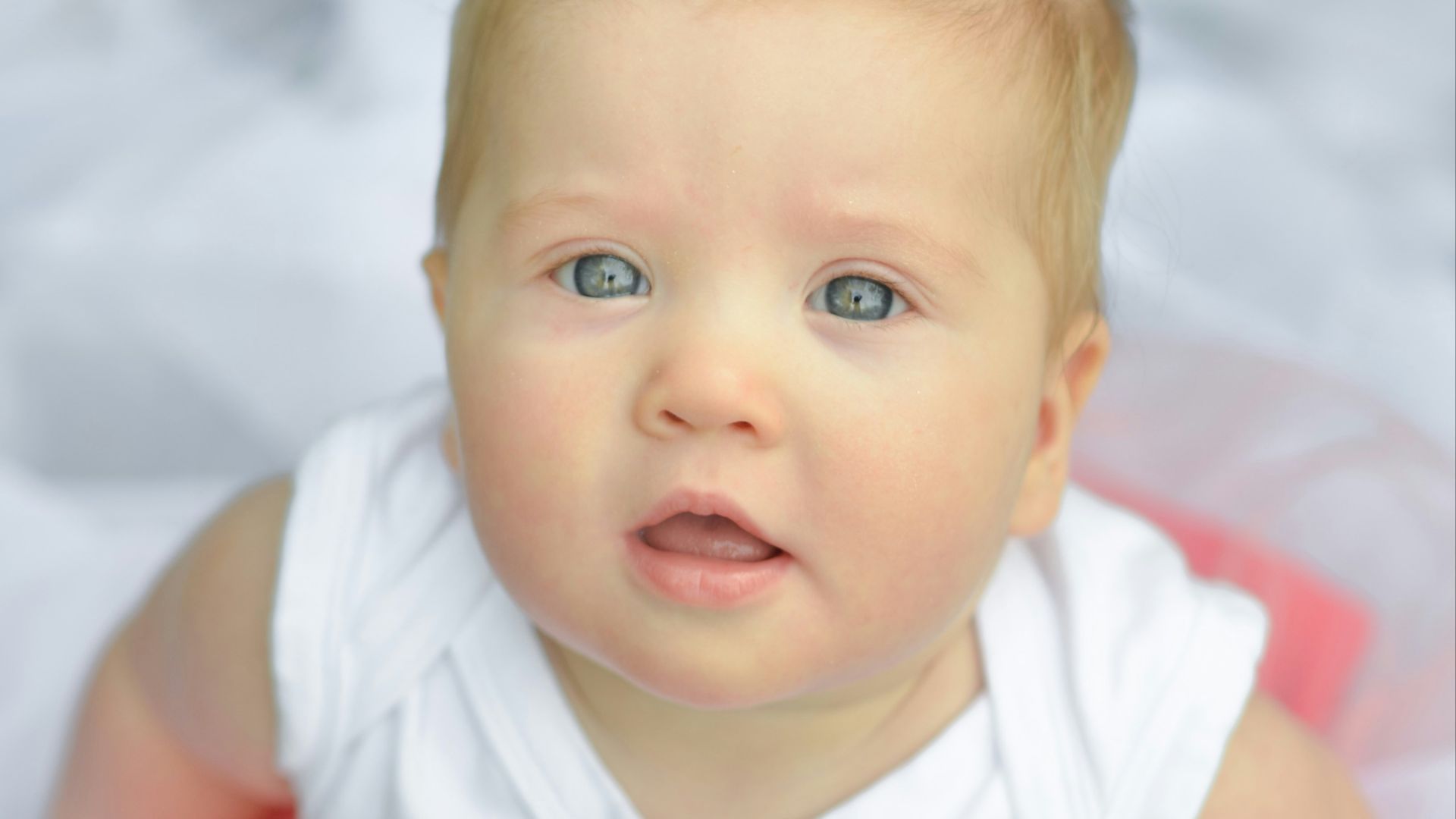 baby in white and pink dress
