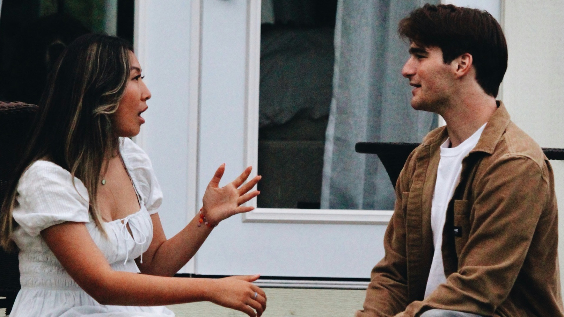 a man and woman sitting on a porch