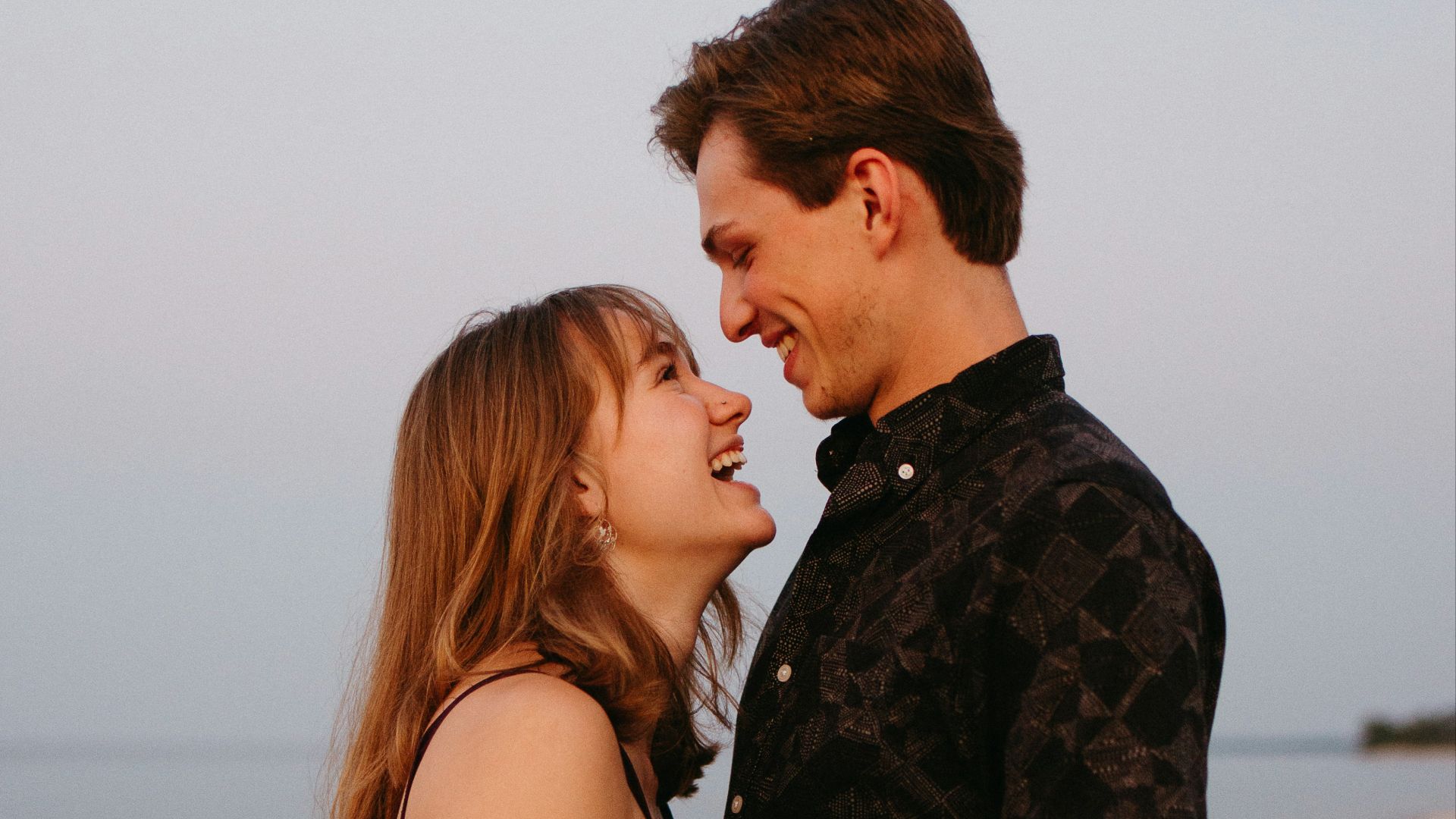 man and woman kissing each other during daytime