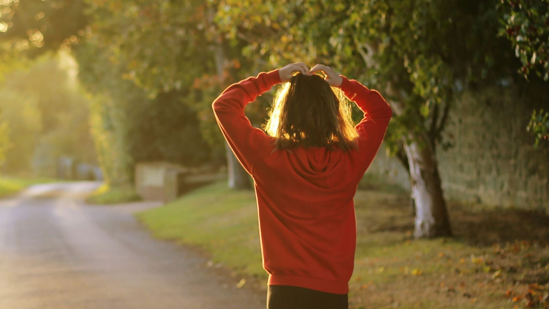 woman walking on pathway during daytime