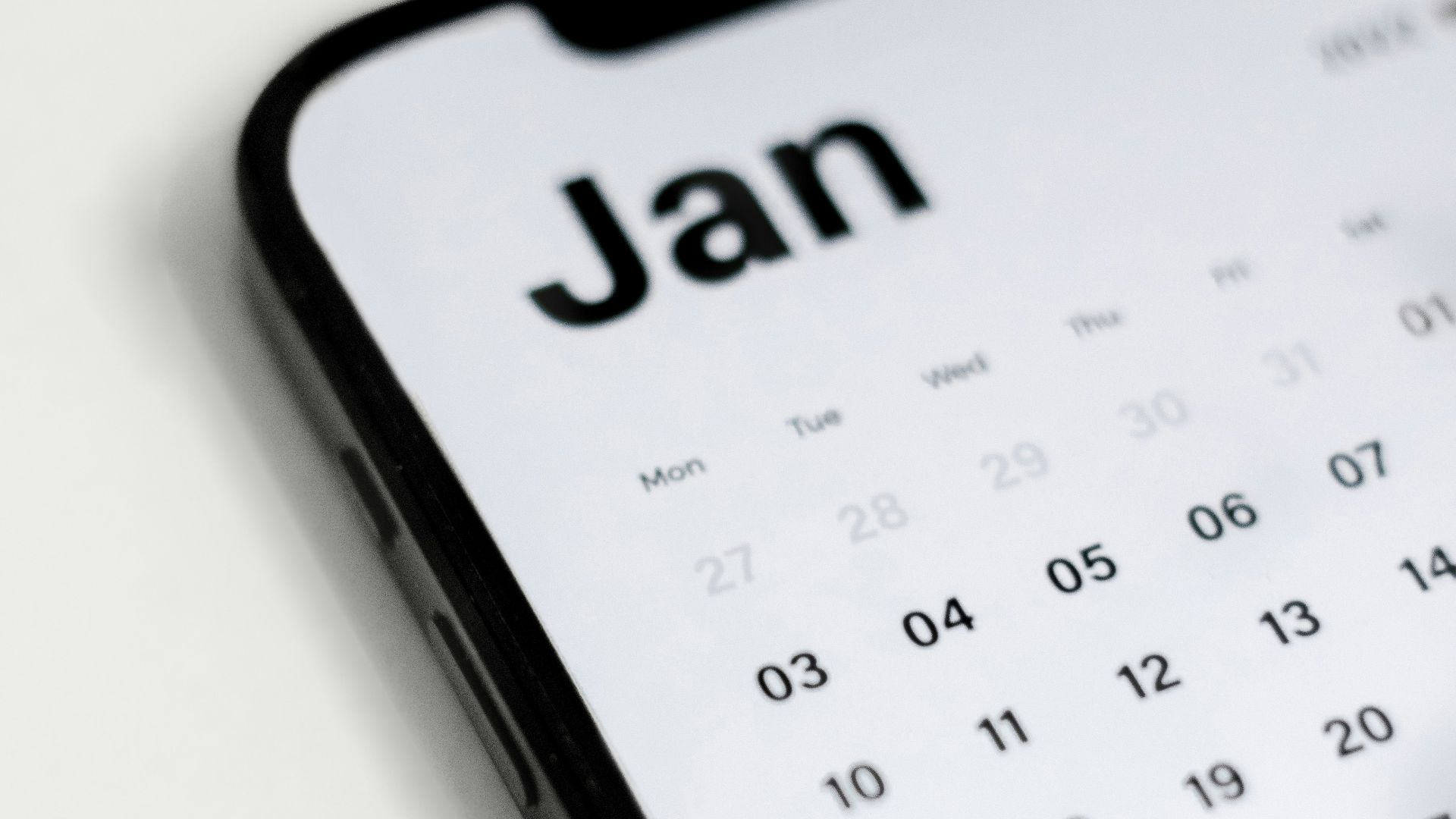 a close up of a cell phone with a calendar on it