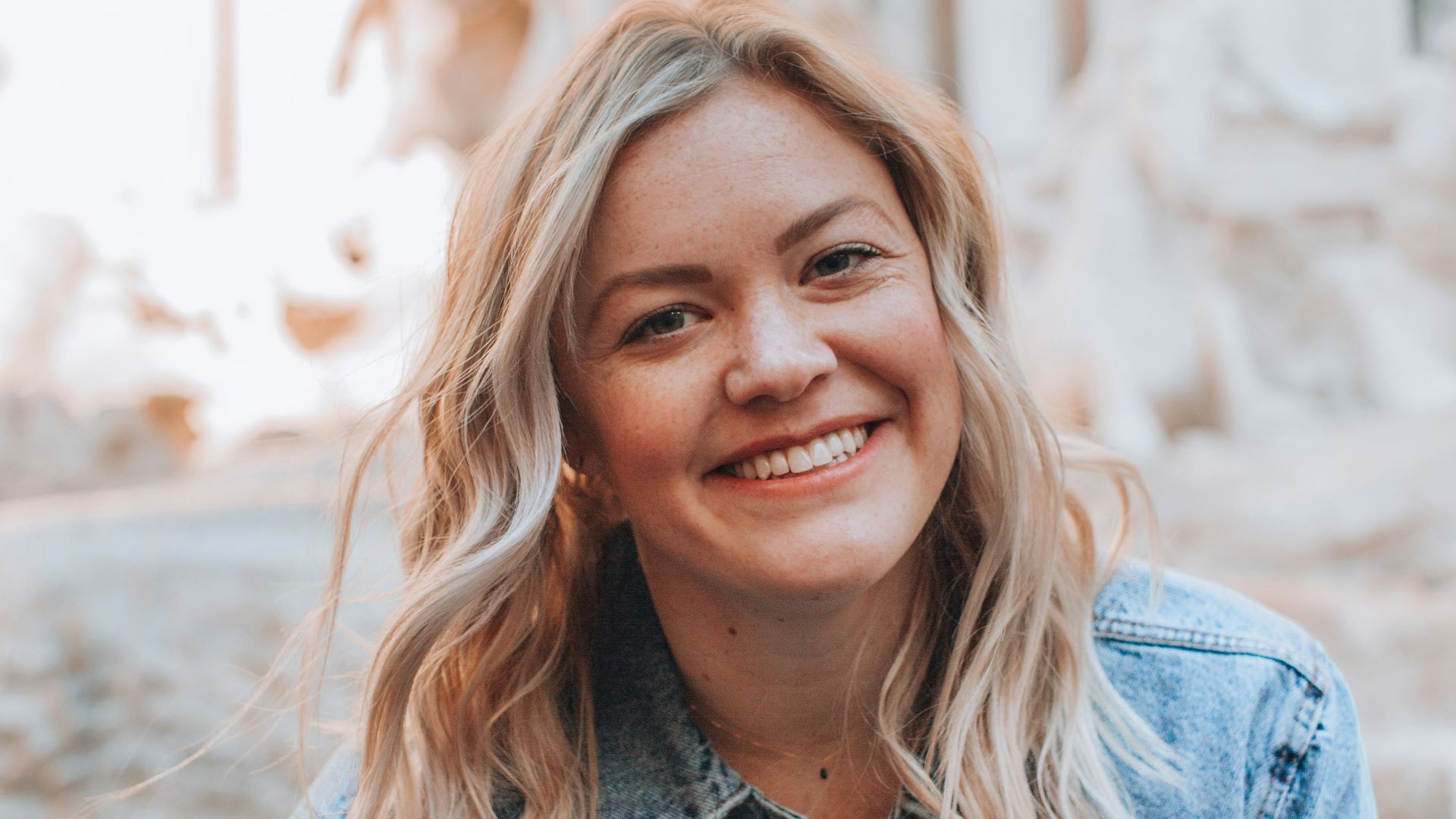 woman smiling wearing denim jacket