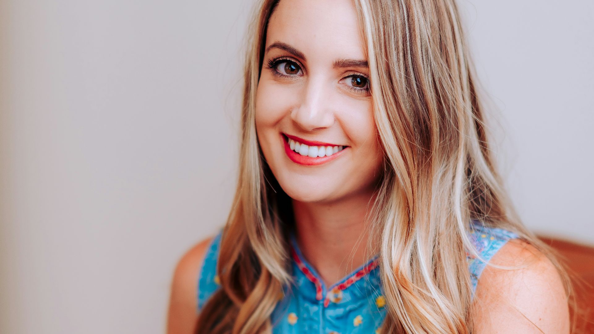 smiling girl in blue sleeveless dress