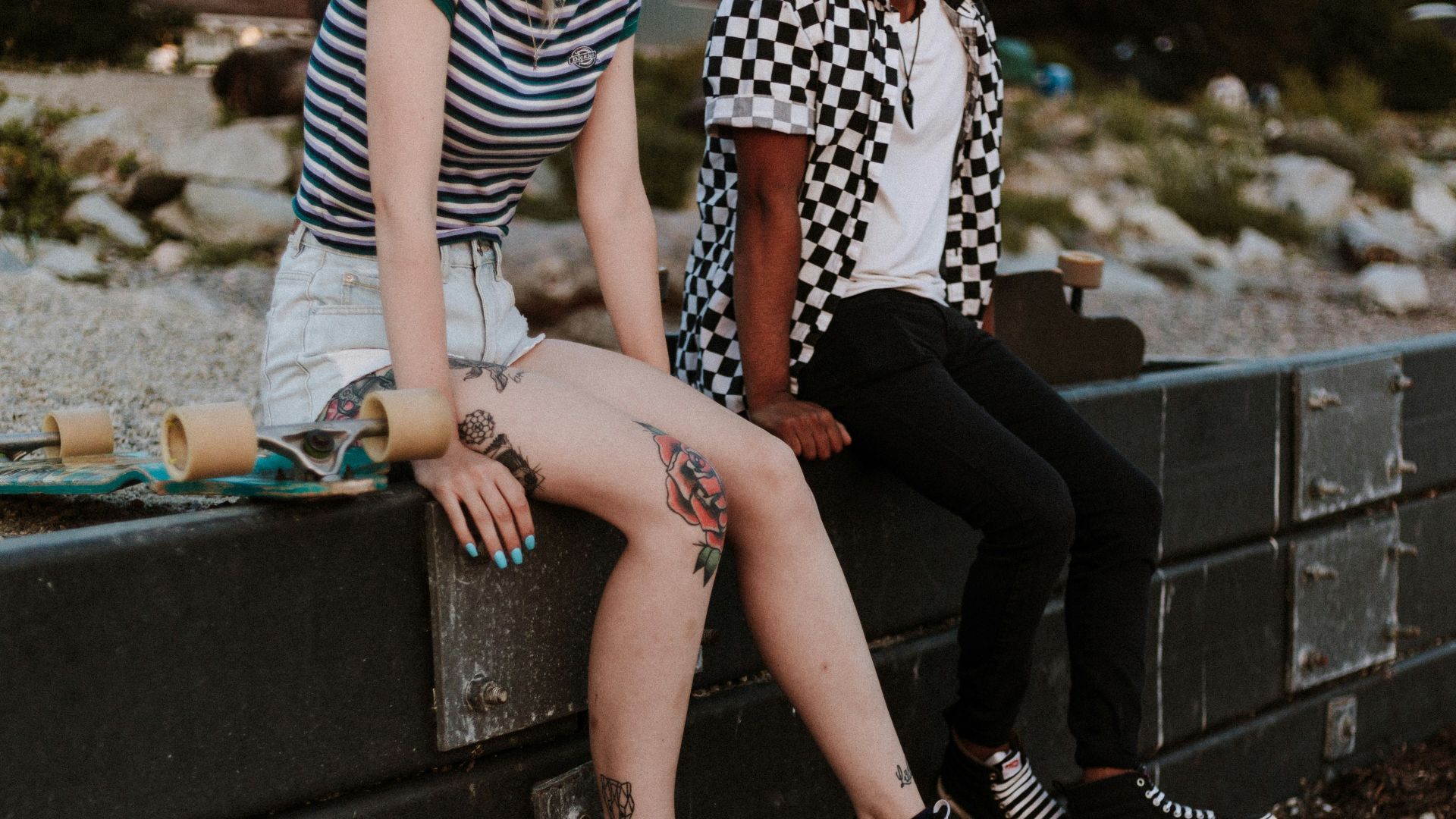 two person sits on fence