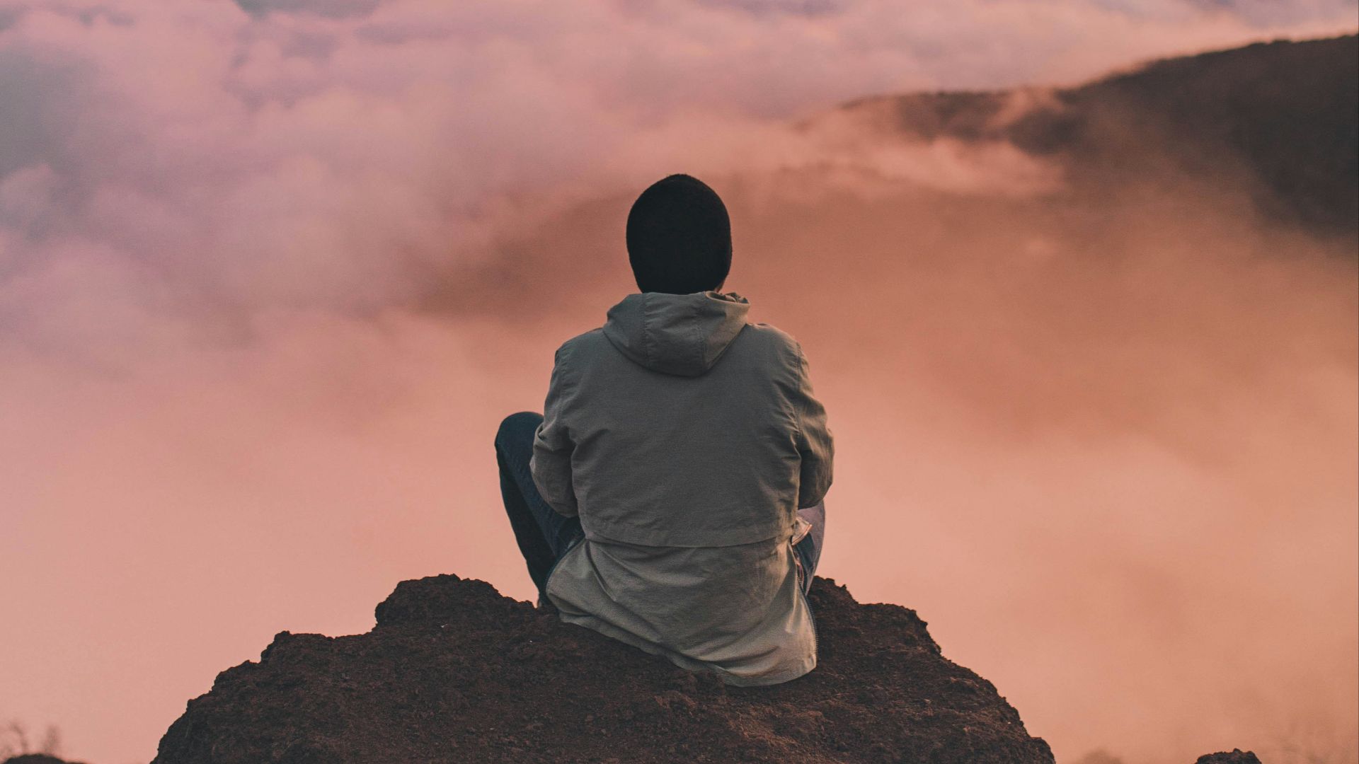 man sitting on cliff