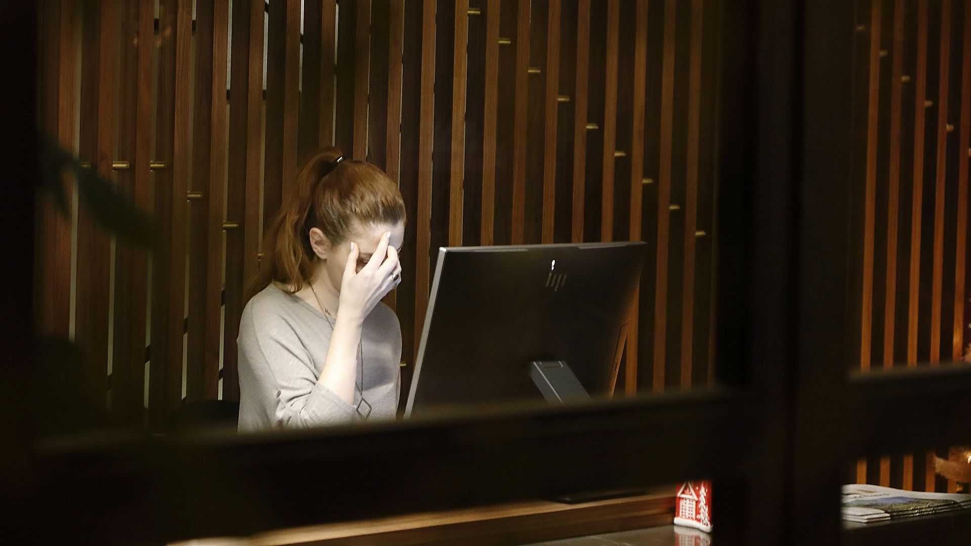 a woman sitting in front of a laptop computer