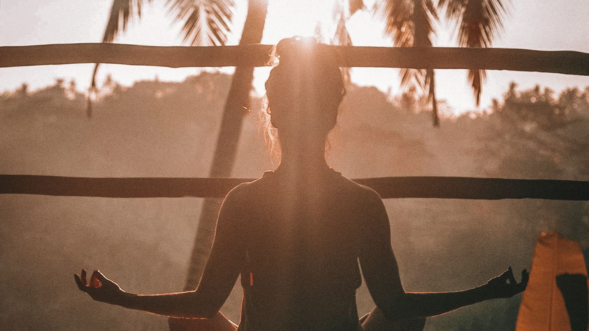 woman doing yoga meditation on brown parquet flooring