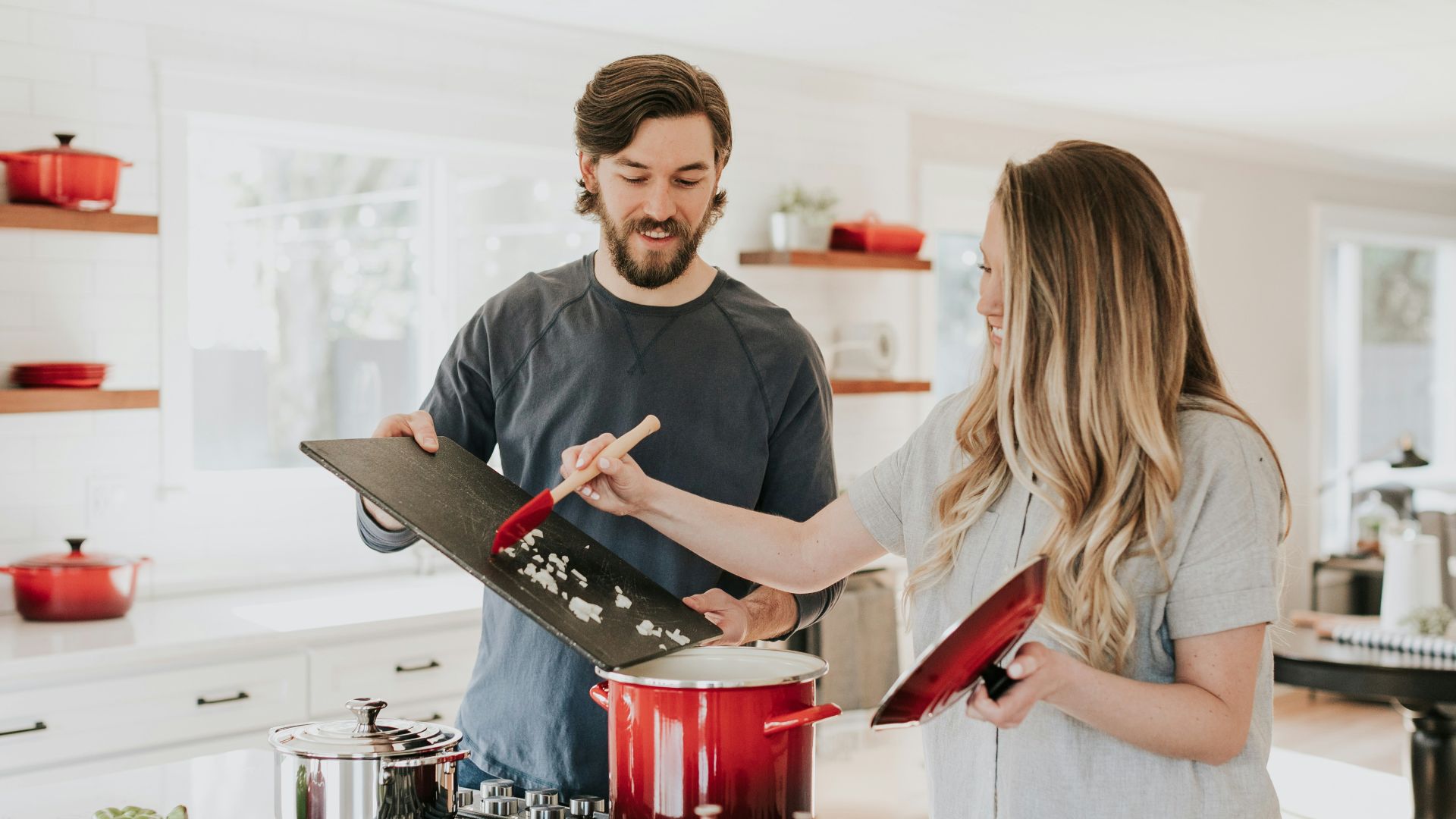 man assisting cooking woman
