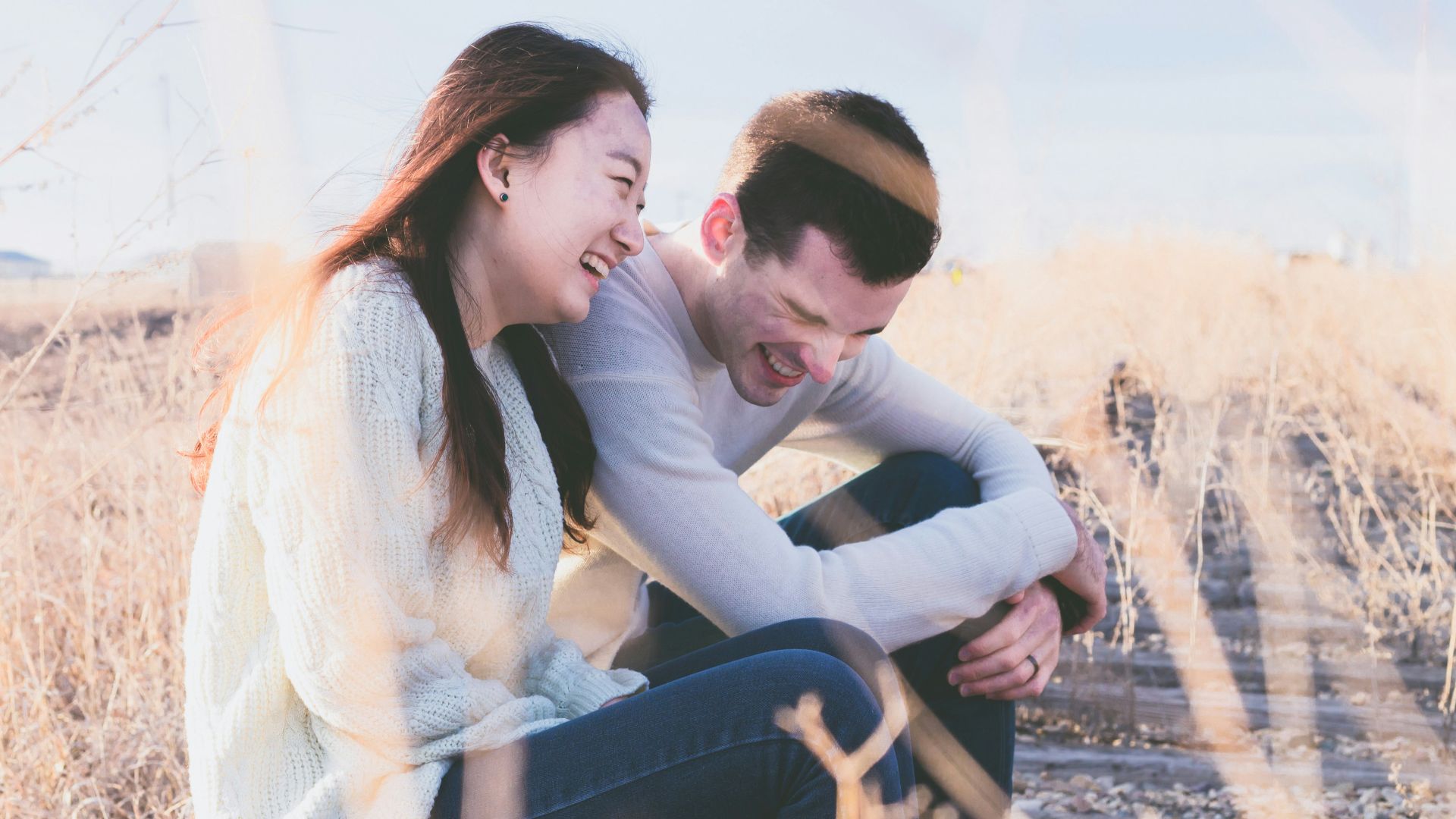 photo of man and woman laughing during daytime