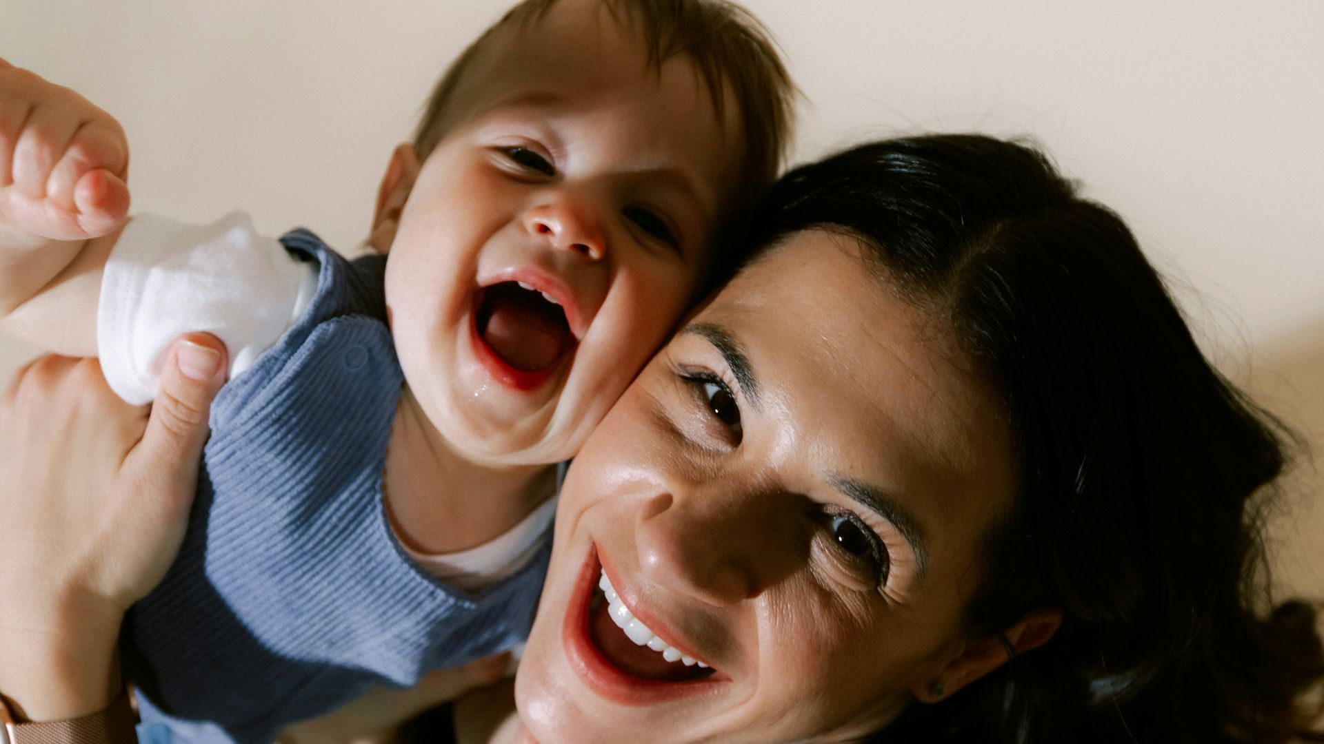 Mother and baby laughing together joyfully