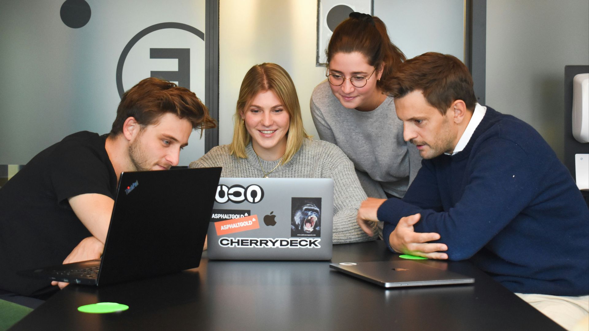 woman in black long sleeve shirt sitting beside woman in gray sweater